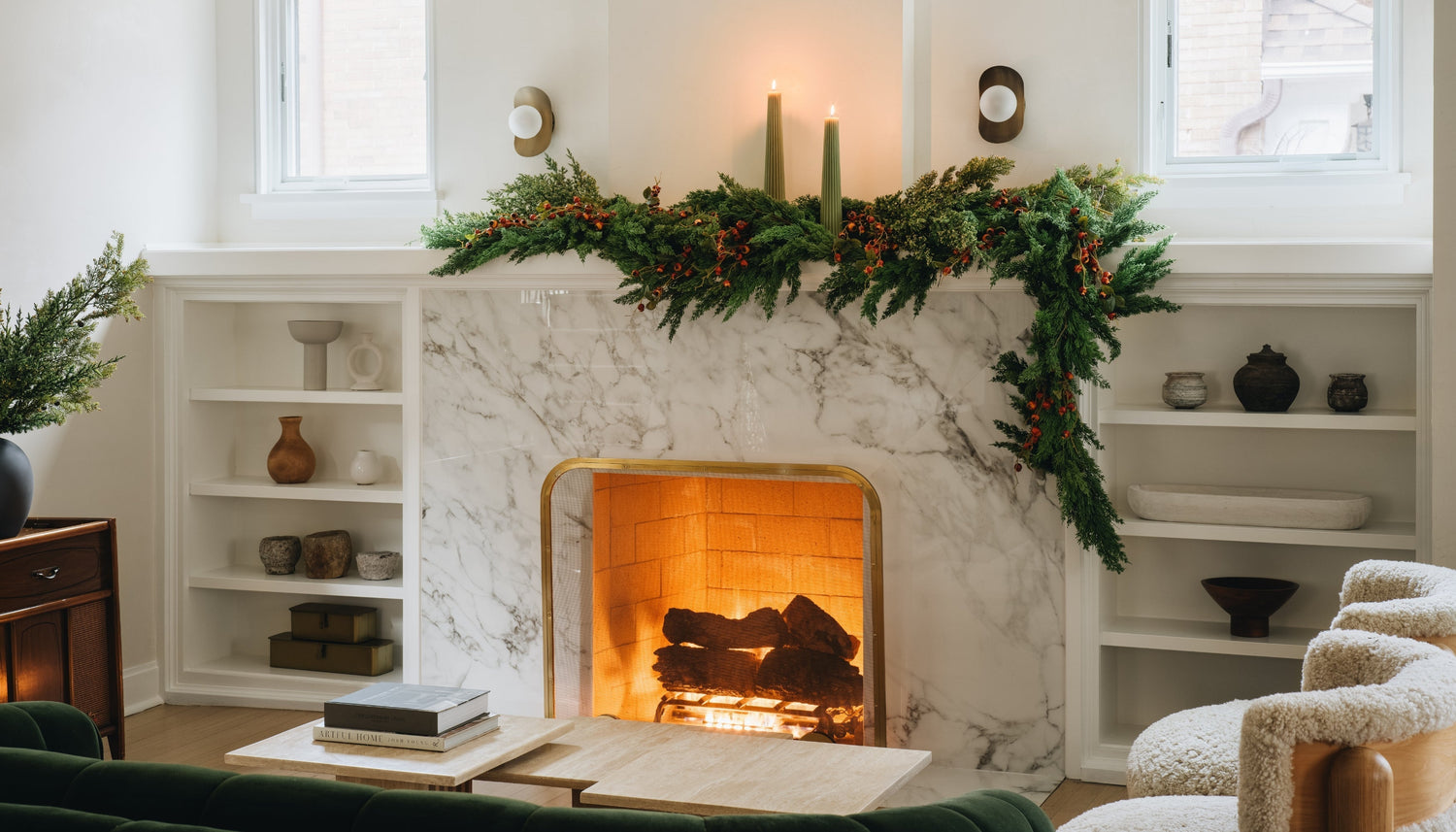 Fireplace mantel styled with asymmetrical cedar garland