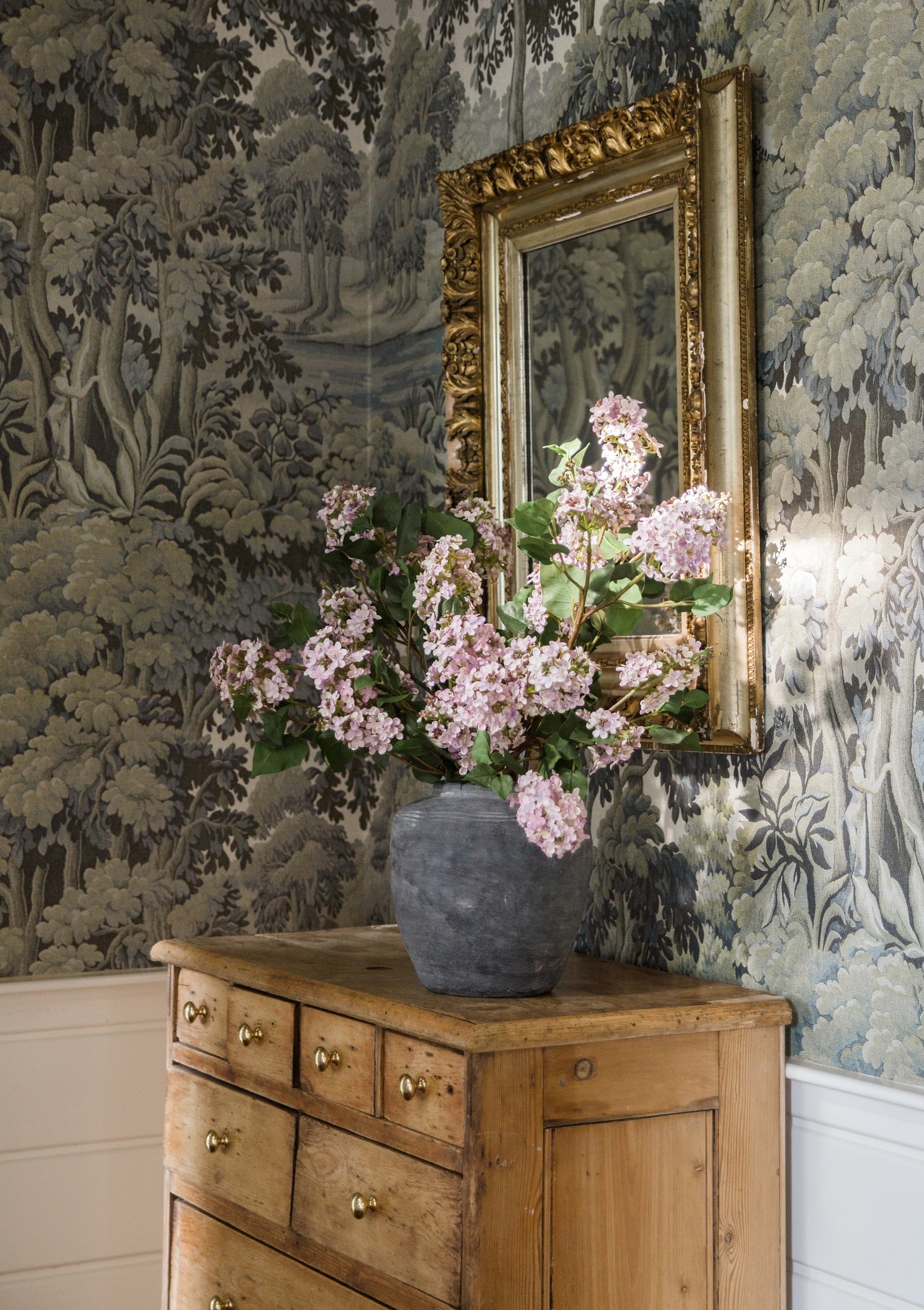 lilacs in rustic concrete vase