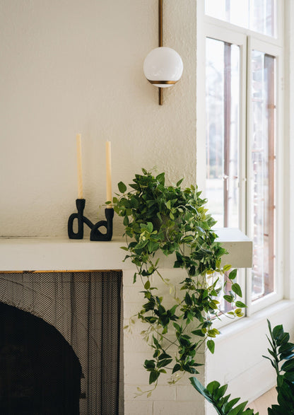 Mantel with Black Resin Candle Holder and Artificial Plant