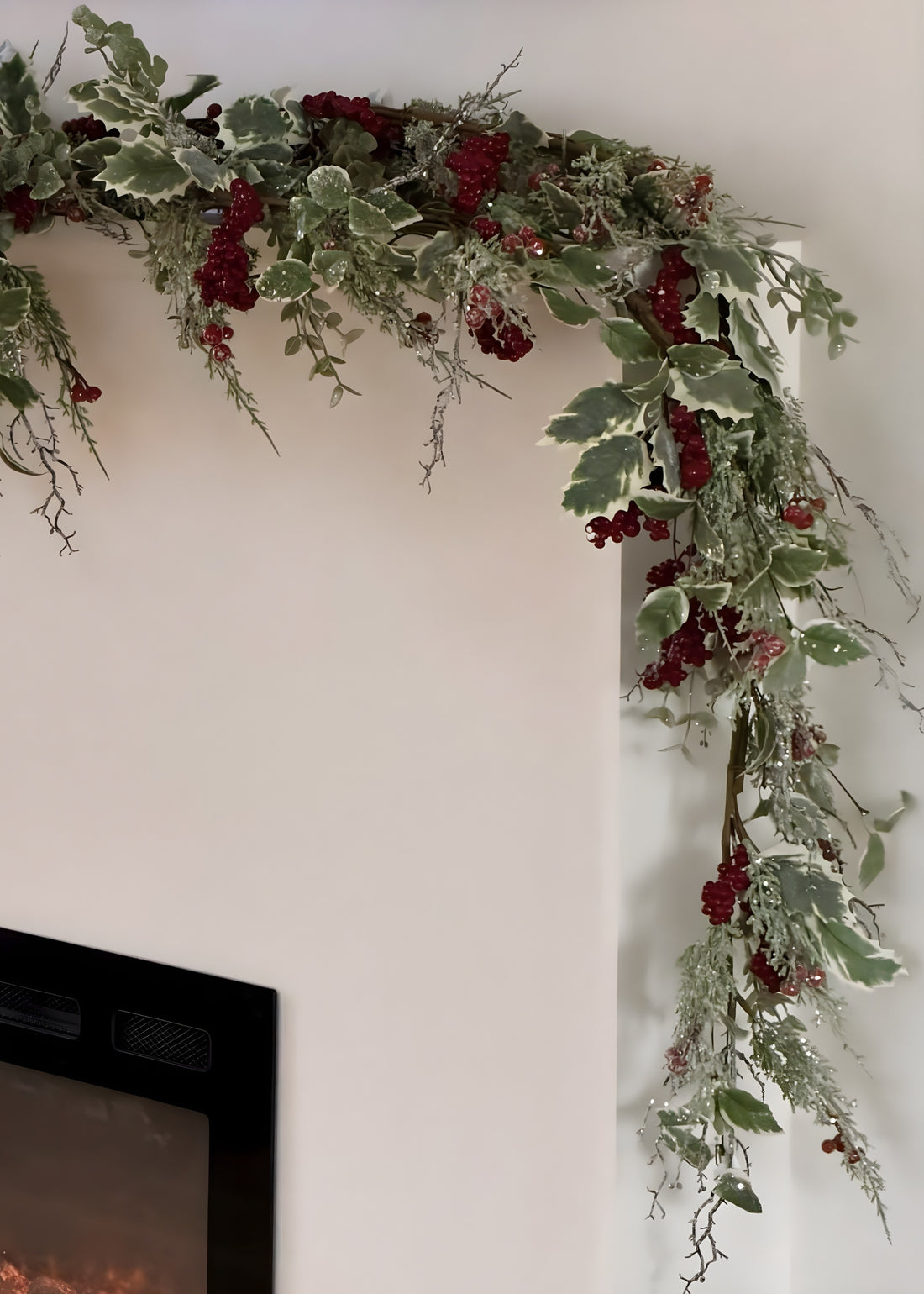 frosted holly garland on fireplace mantel