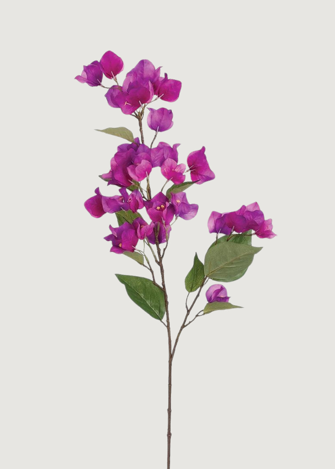 Purple faux bougainvillea spray with trailing blossoms and green leaves