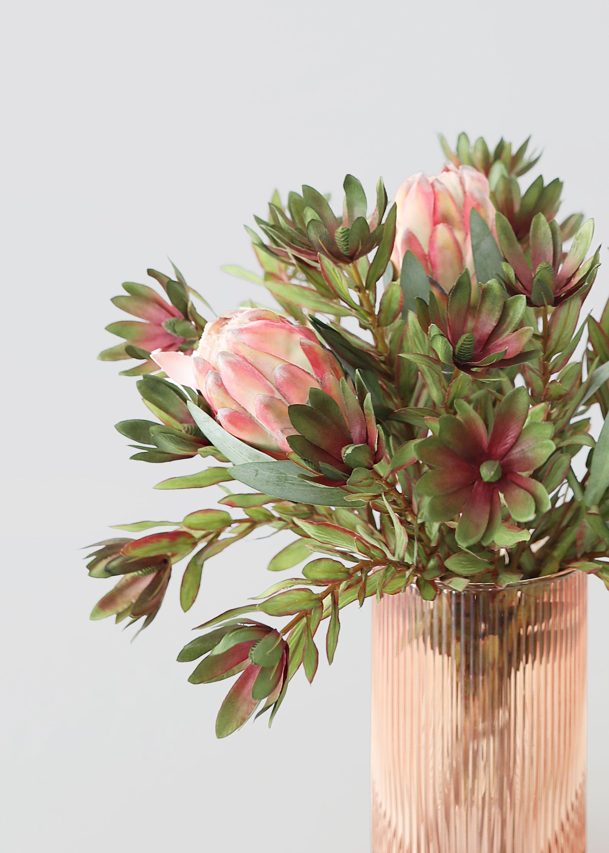 Bouquet of pink protea flowers an greenery