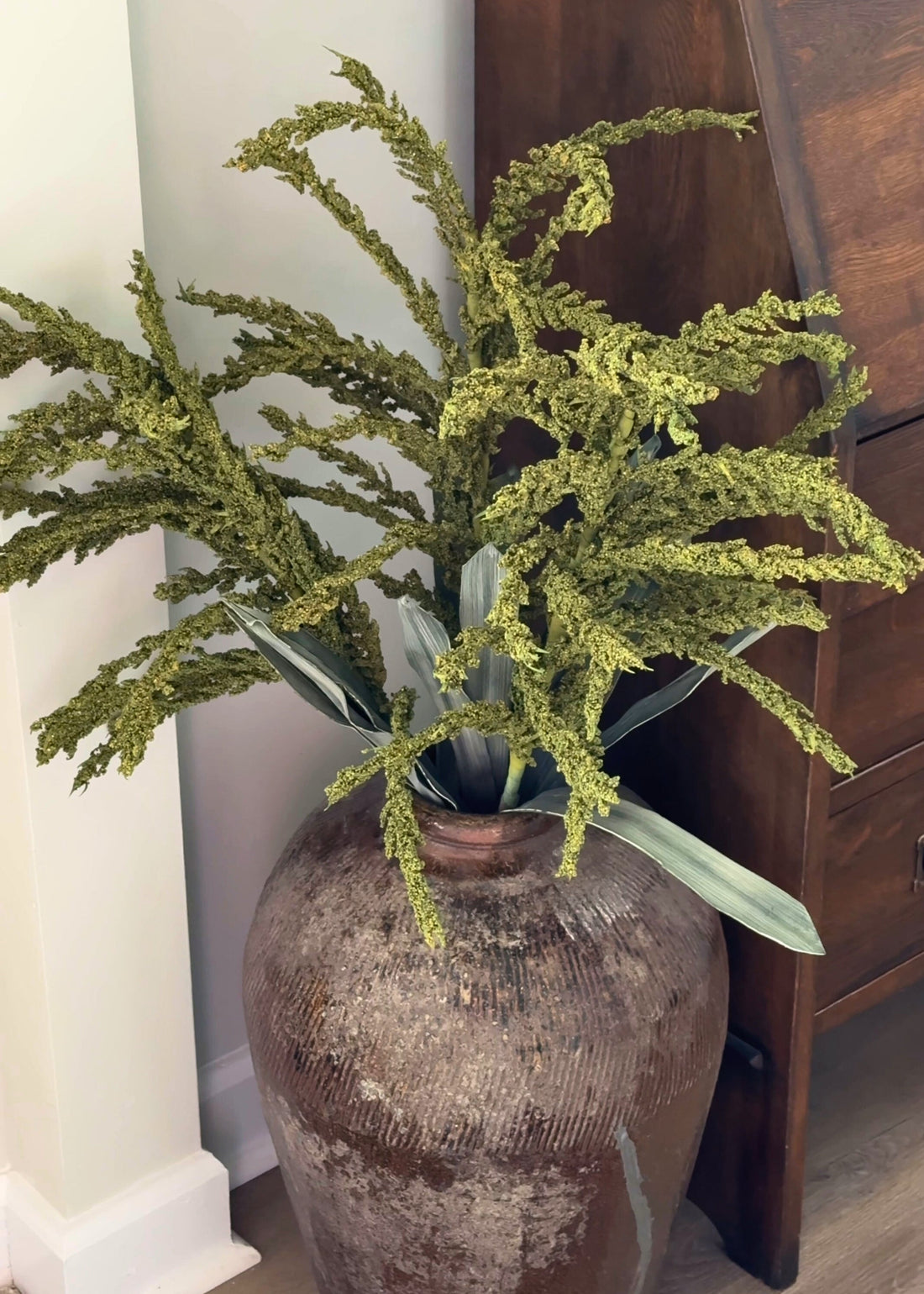 Decorative green seed plant in a textured vase