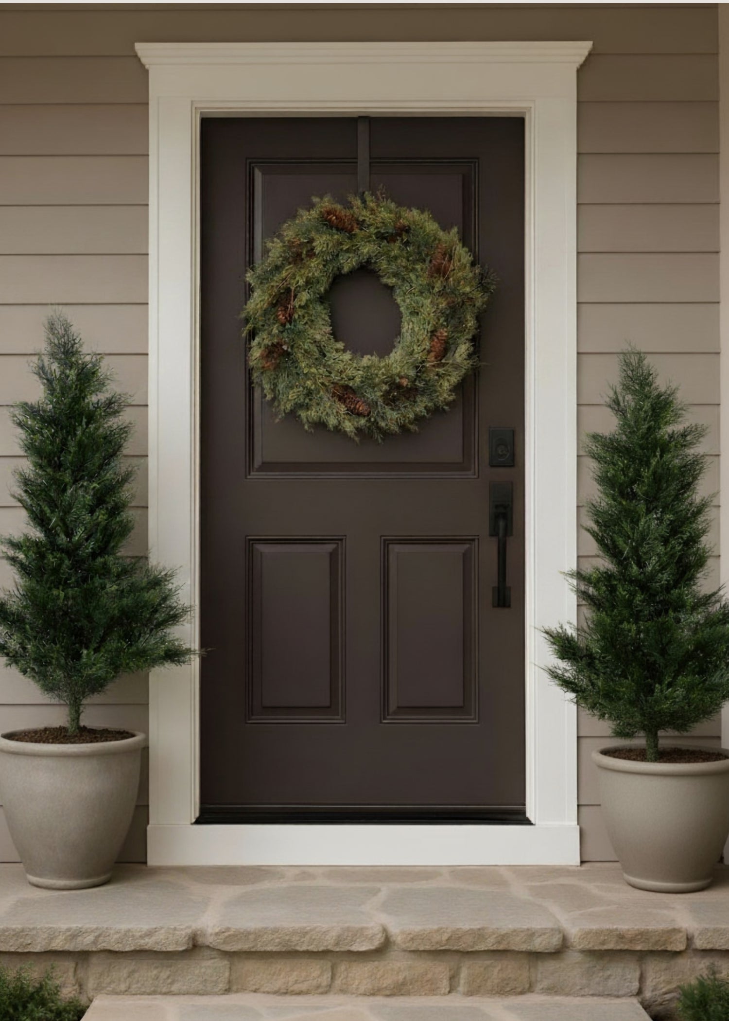 Artificial pinecone wreath on a brown door