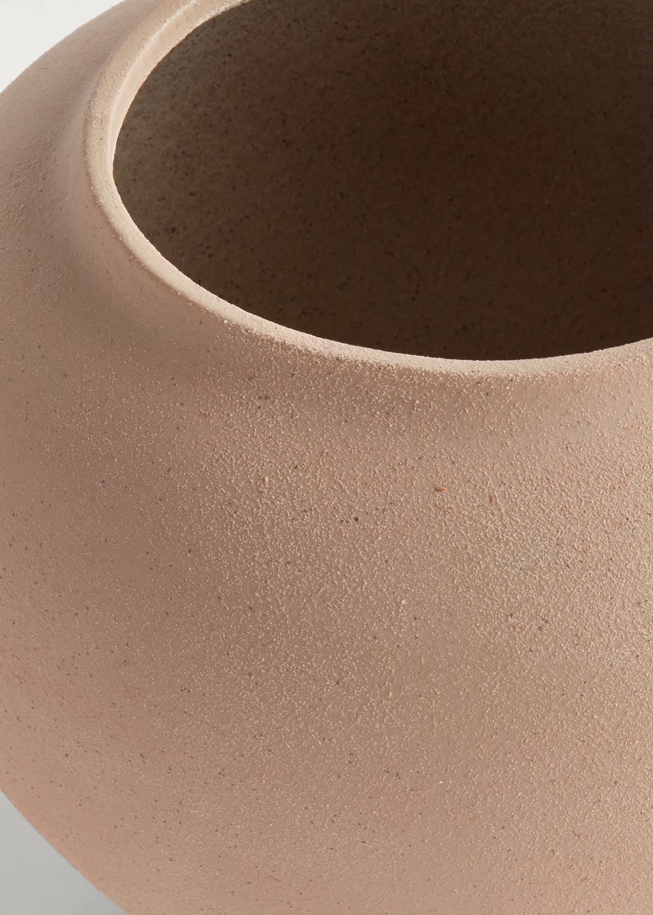 Close-up of tan stoneware vase