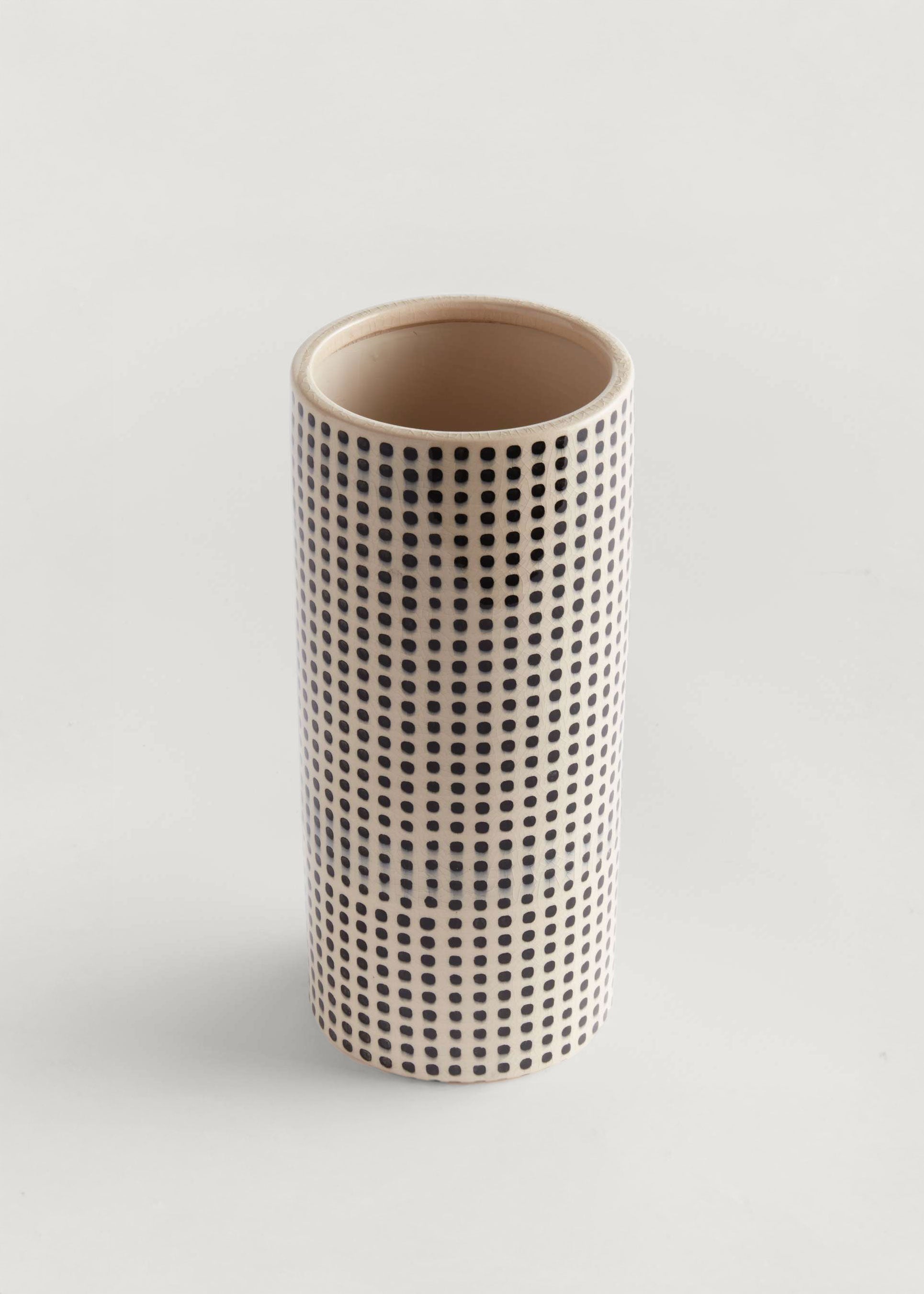 Cylindrical ceramic vase with a black dot pattern