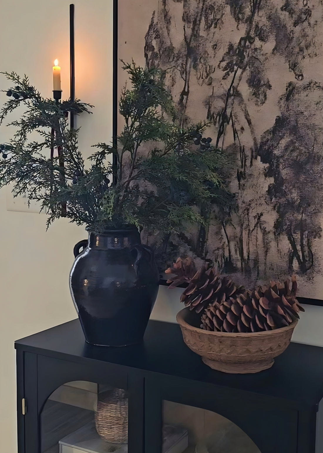 Juniper branches styled in black vase with handles