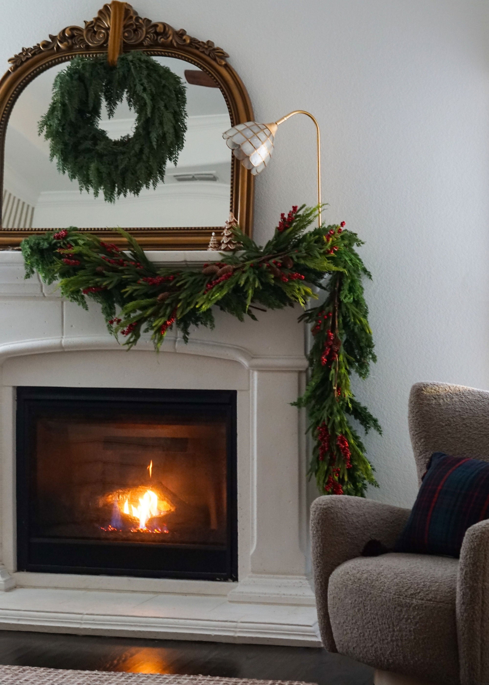 fireplace garland made of cedar, pine, and red berries