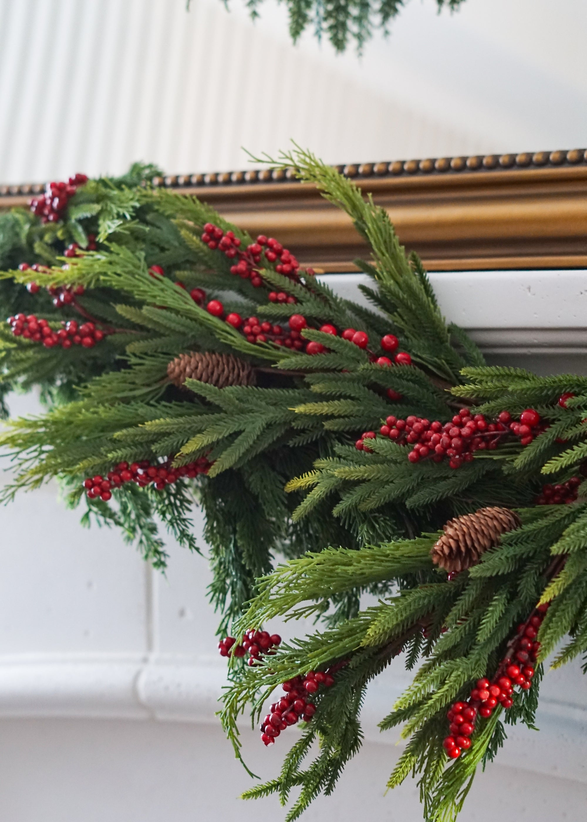Close-up of pine and red berry stems in garland
