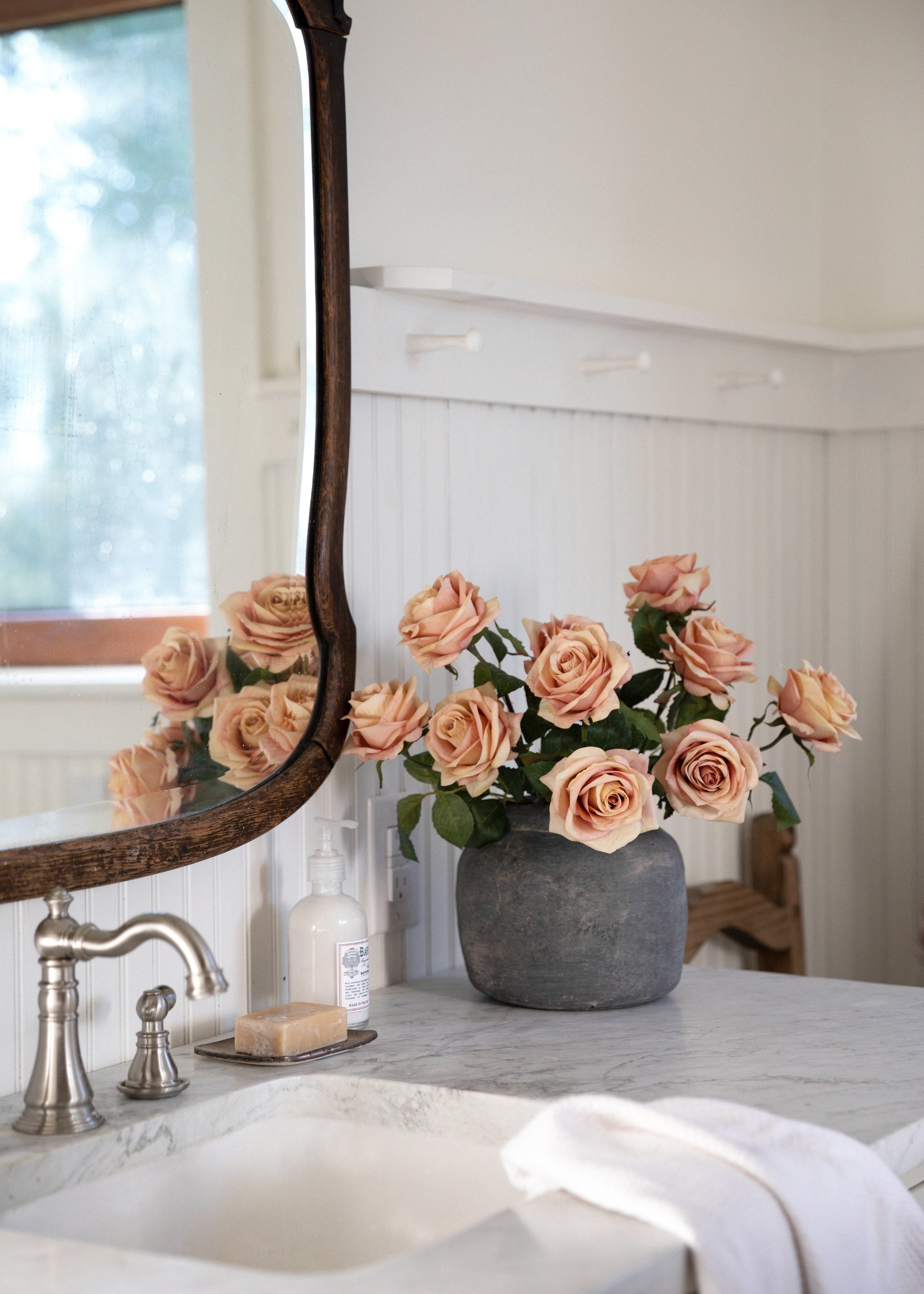 Silk Roses in Cement Vase in Bathroom