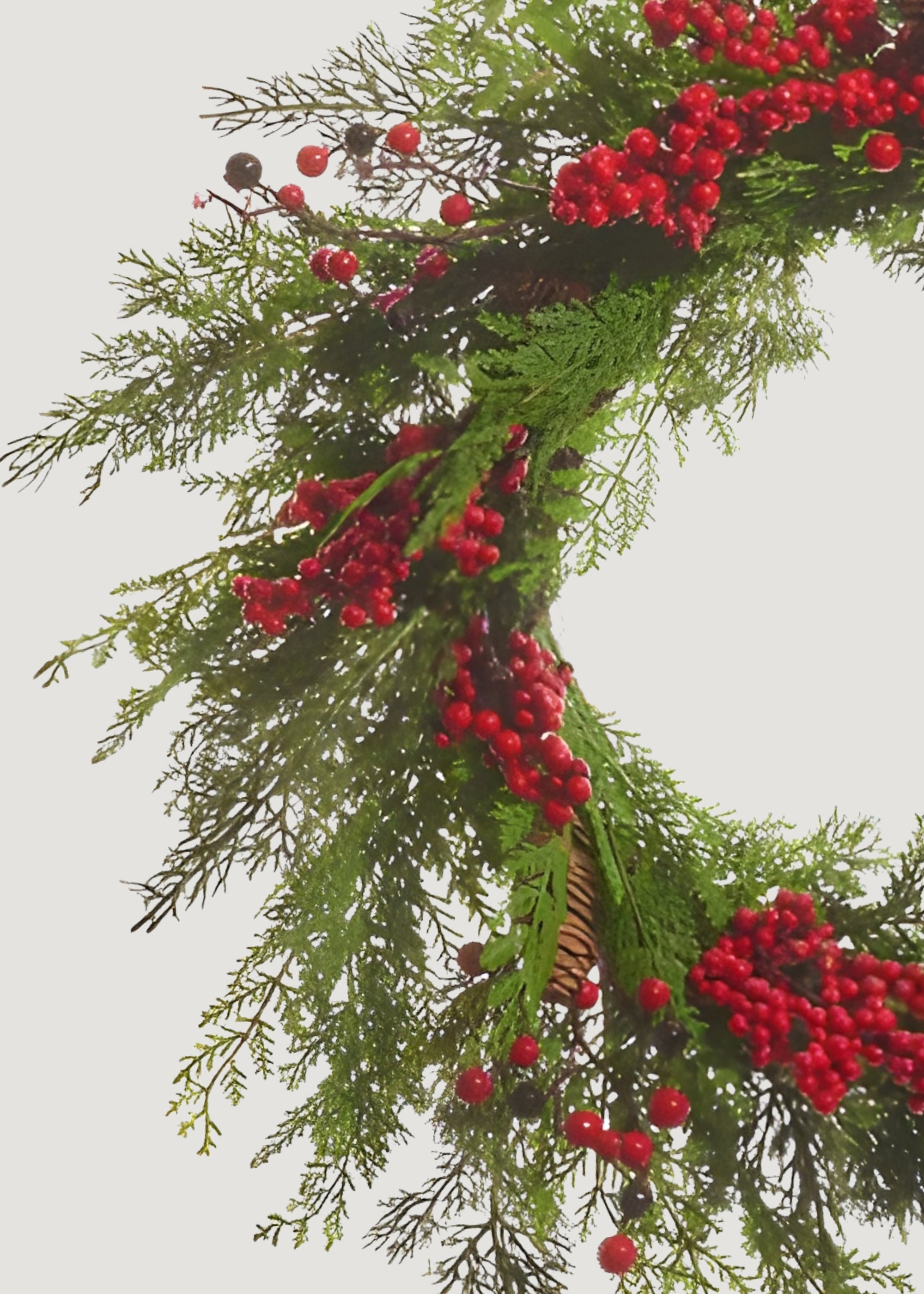 Close-up of cedar wreath with red berries