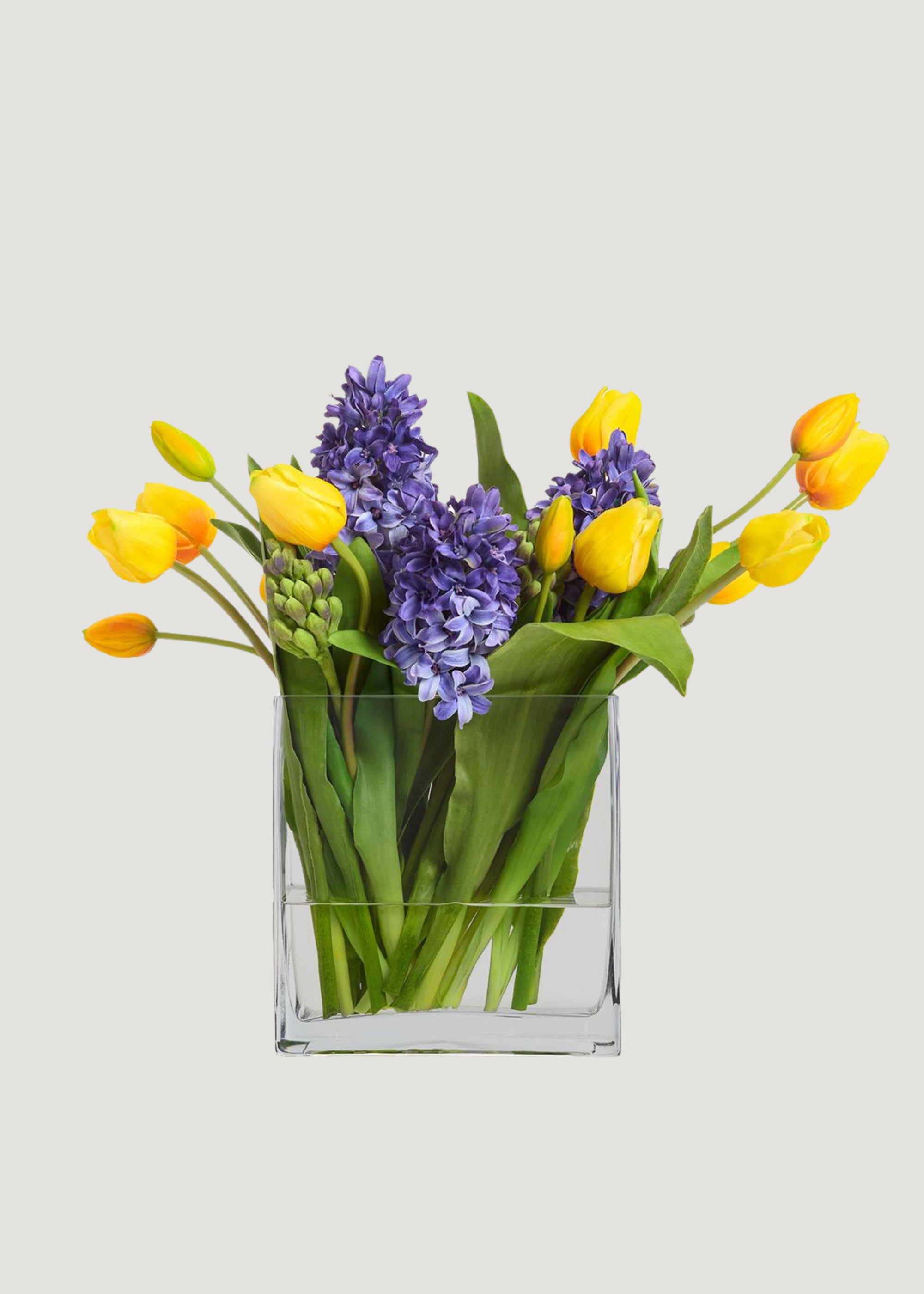 Blue Fake Hyacinth and Yellow Tulip Arrangement in Glass Vase