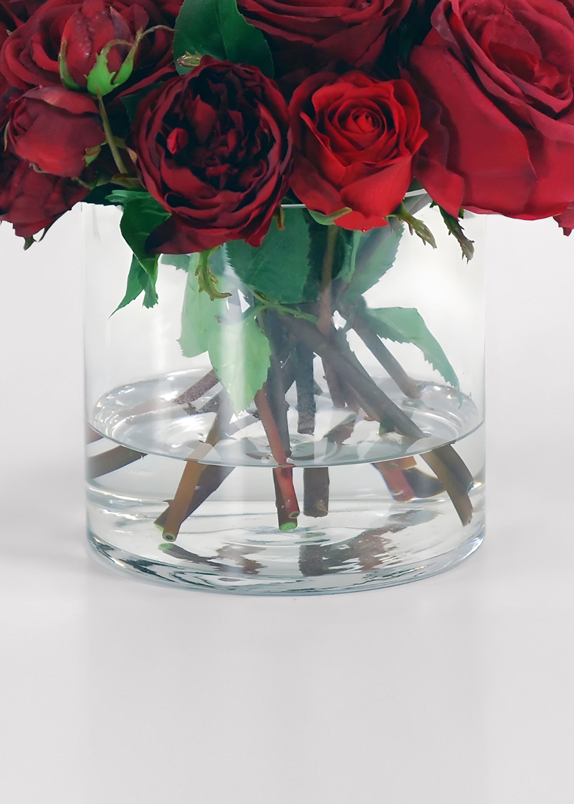 Clear glass vase with red and burgundy roses