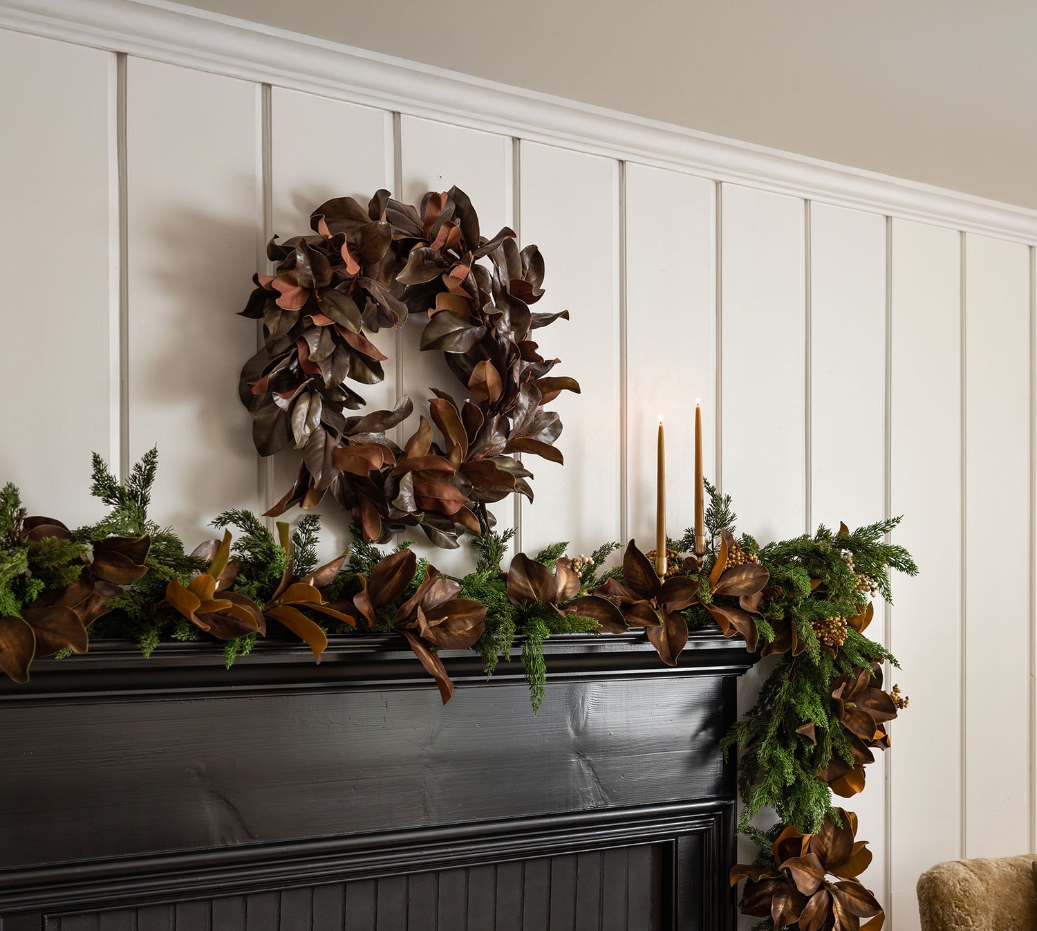 Decorative magnolia wreath and garland on a fireplace