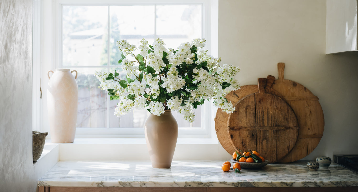 A cared for and clean white flower arrangement. | Afloral