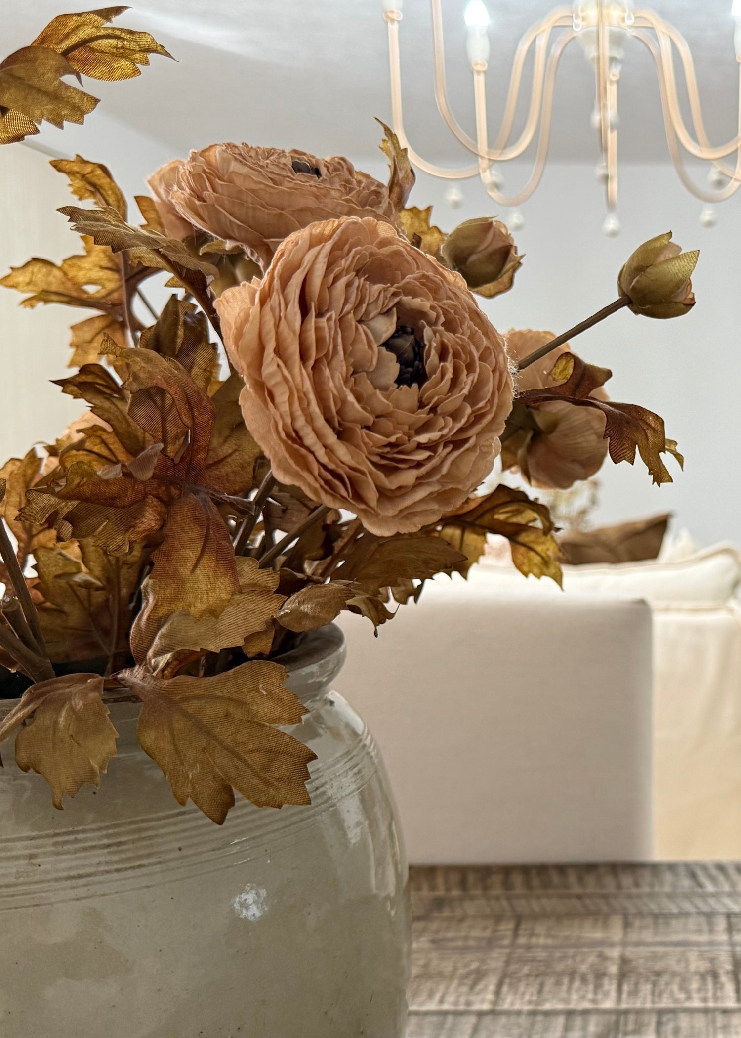 Video of autumn taupe ranunculus arranged in handmade vase