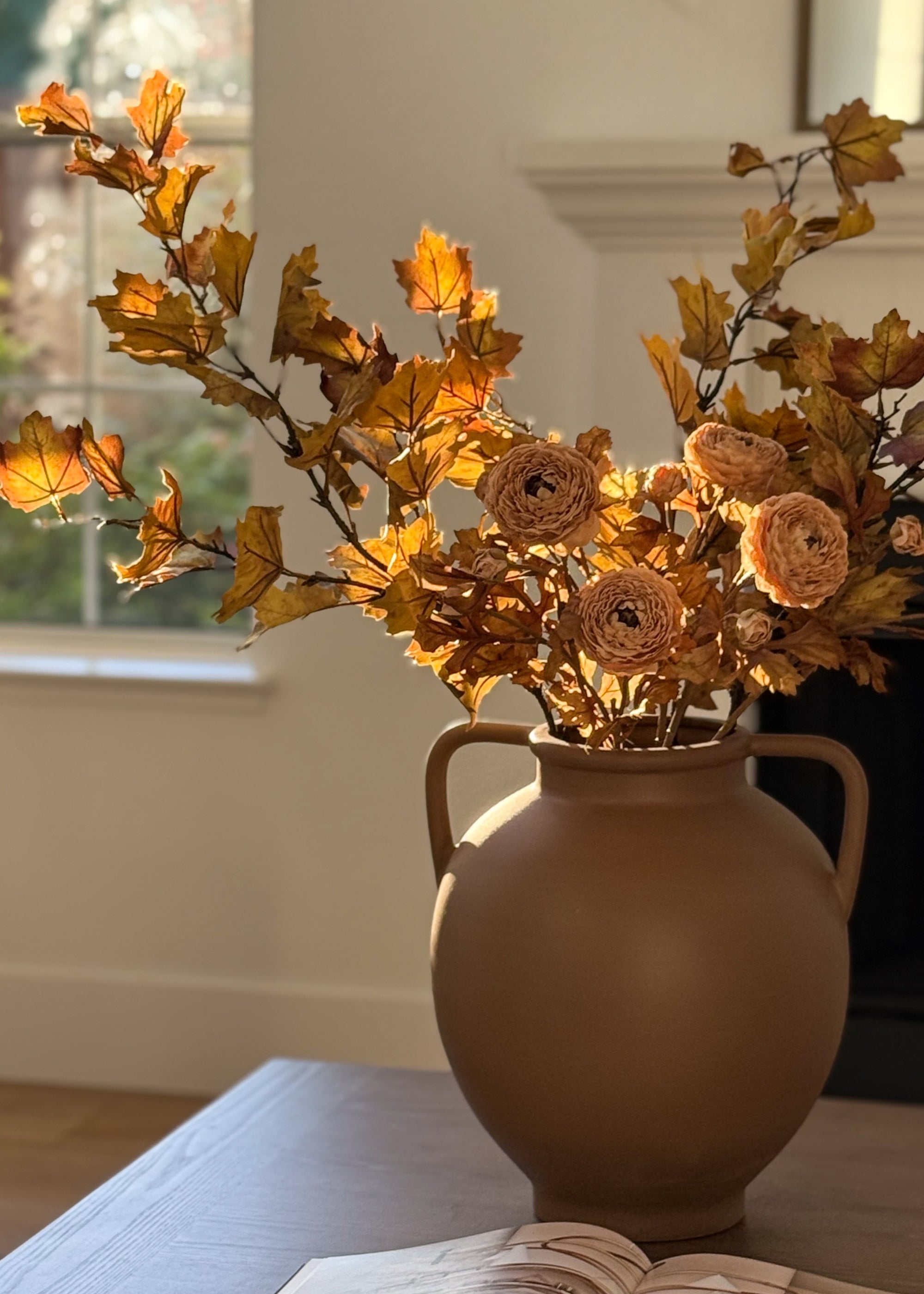 fall faux maple leaf and ranunculus floral arrangement