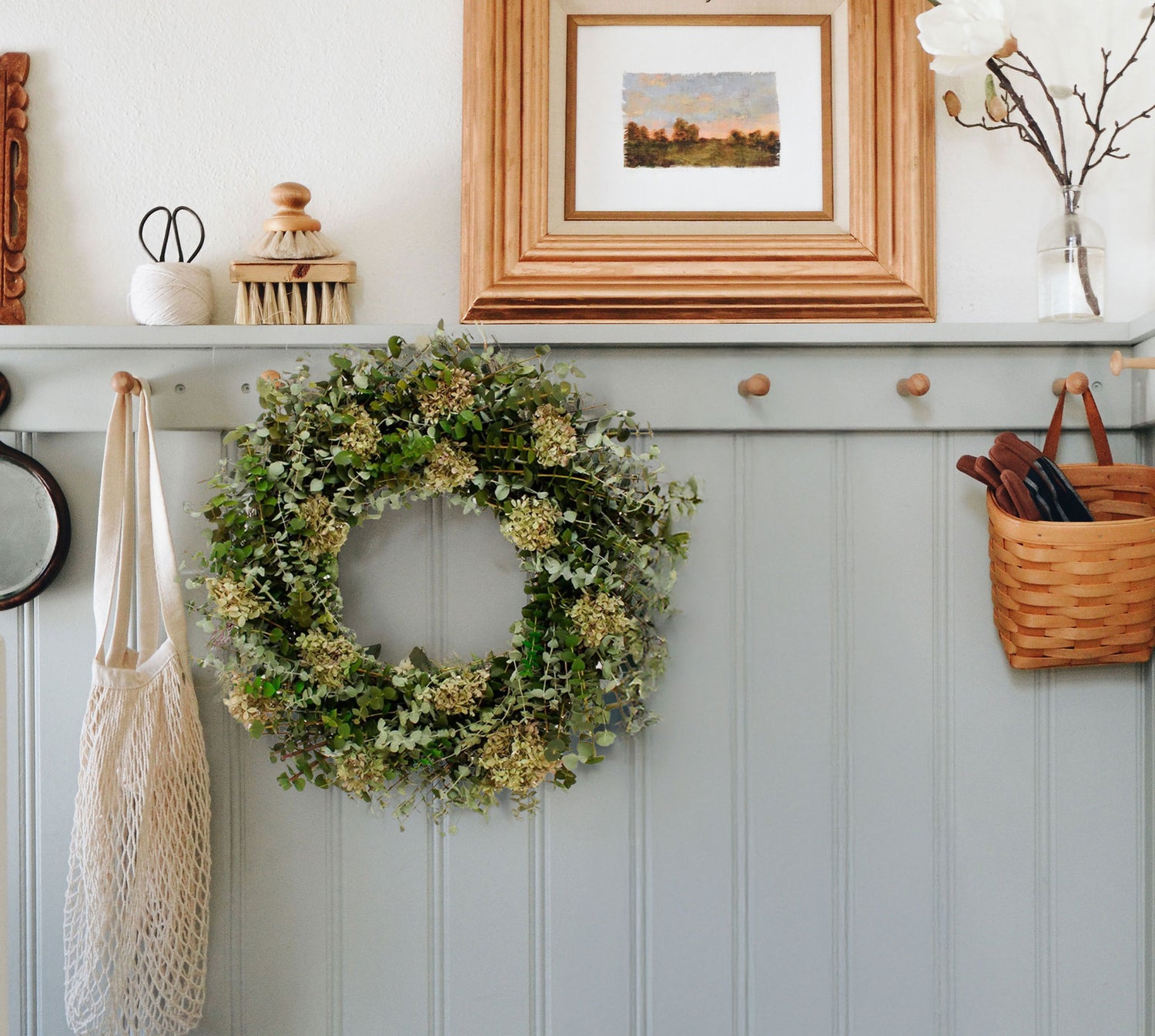 Dried Eucalyptus and Hydrangea Spring wreath hanging in entryway
