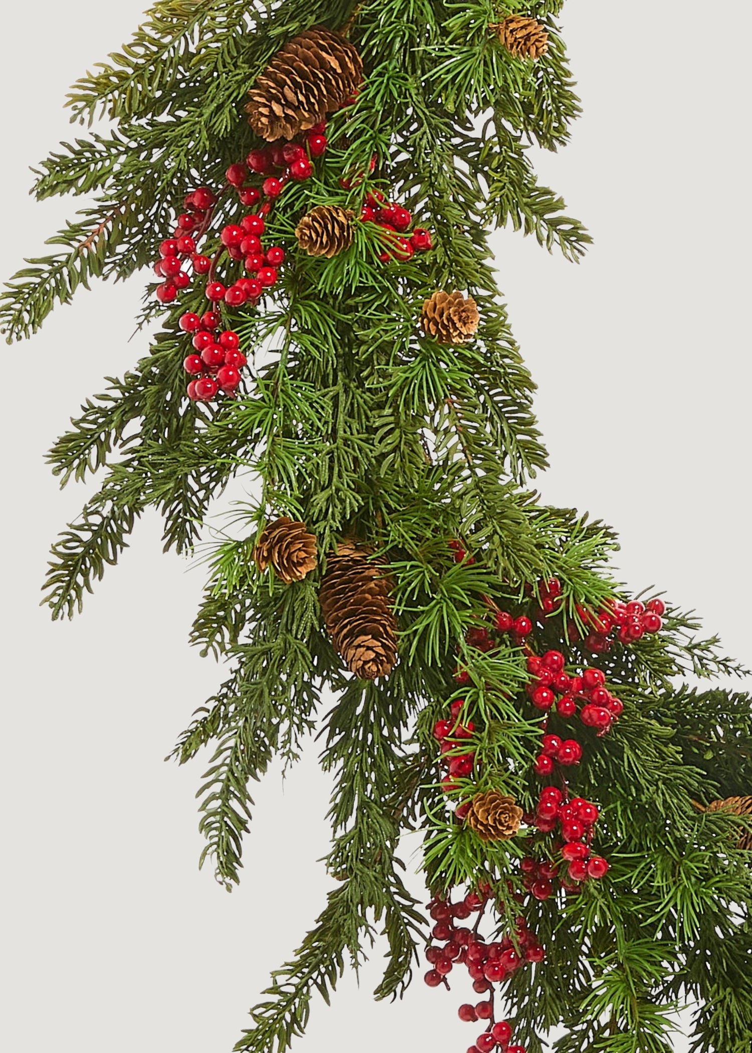 Close-up of faux cedar and red berry wreath