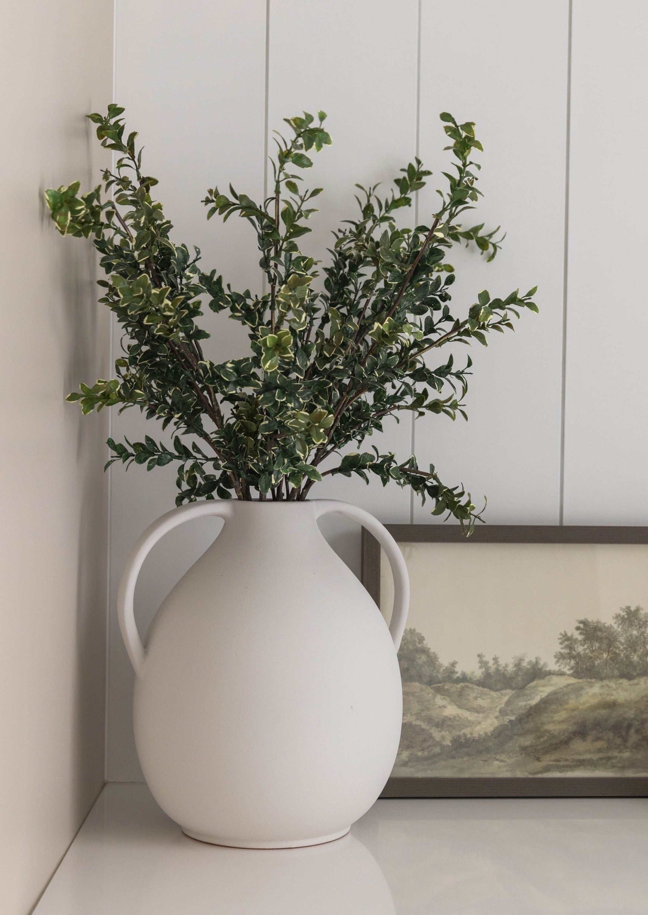 Artificial-Button-Leaf-in-Tall-White-Vase-at-Afloral