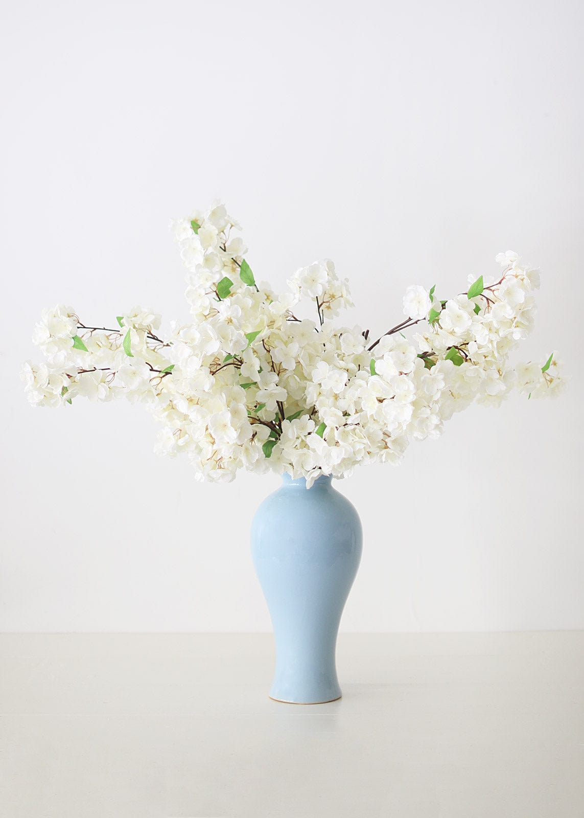 Blue Glossy Vase with White Cherry Blossoms