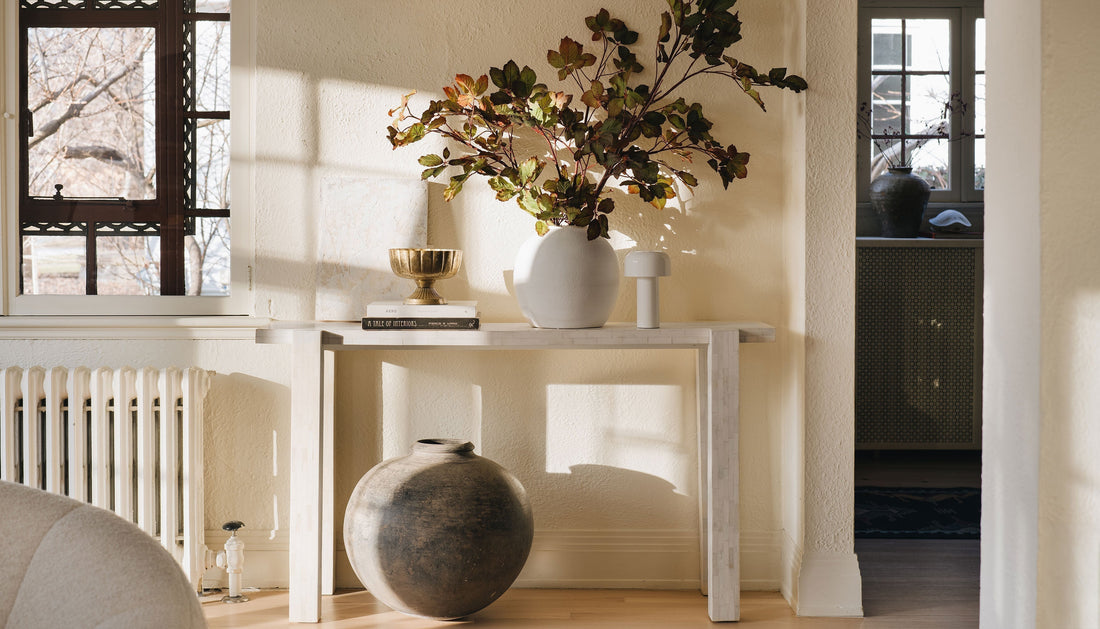 Console table styled with Afloral vases and faux chestnut leaves
