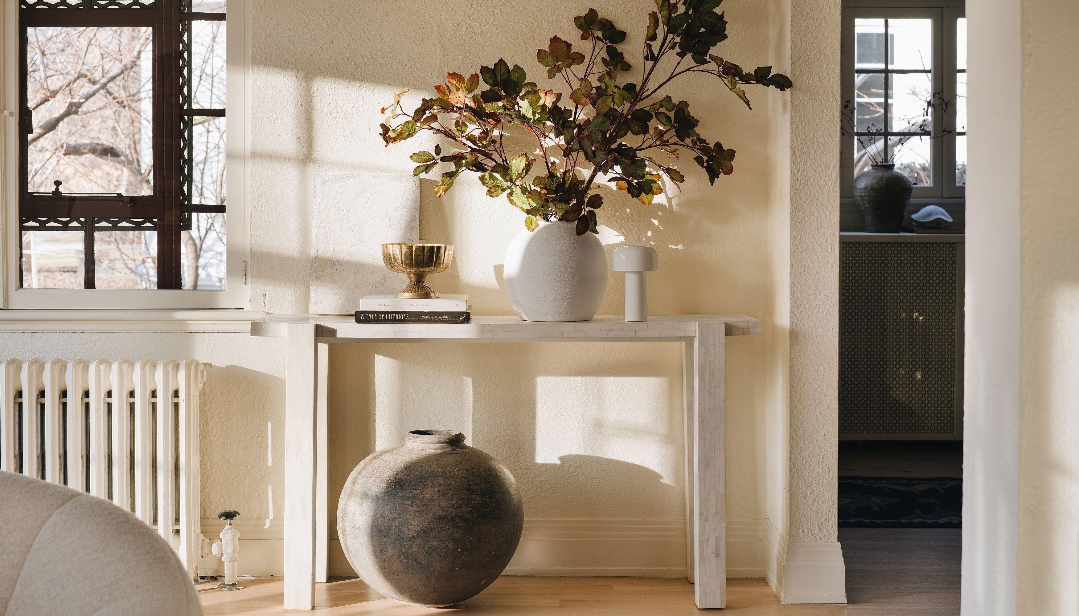 Console table styled with Afloral vases and faux chestnut leaves
