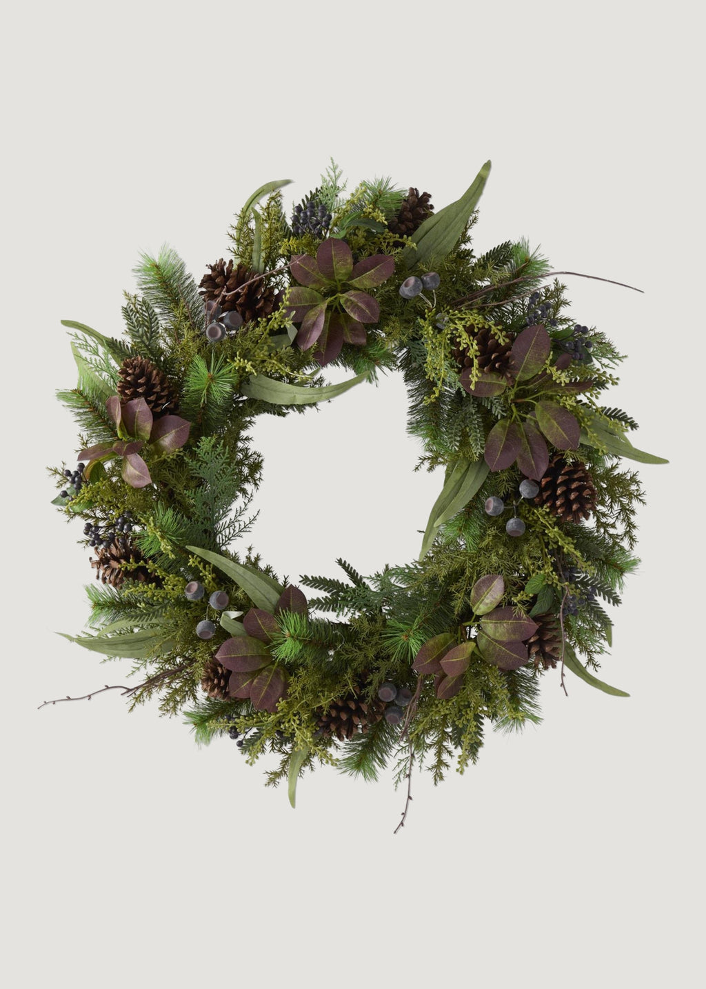 A large mulberry leaf and pine wreath with pinecones.