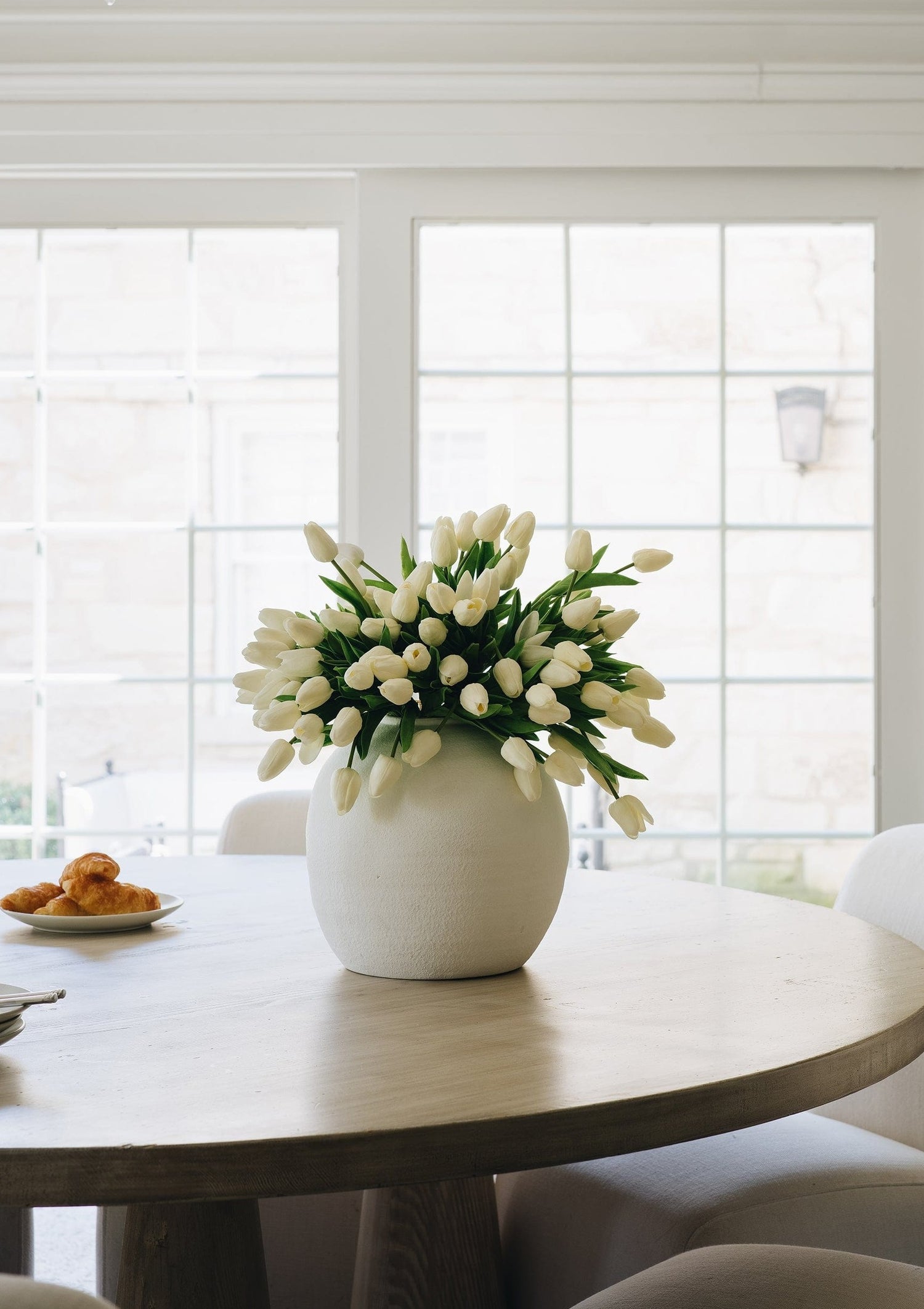 spring fake tulips in white konos vase