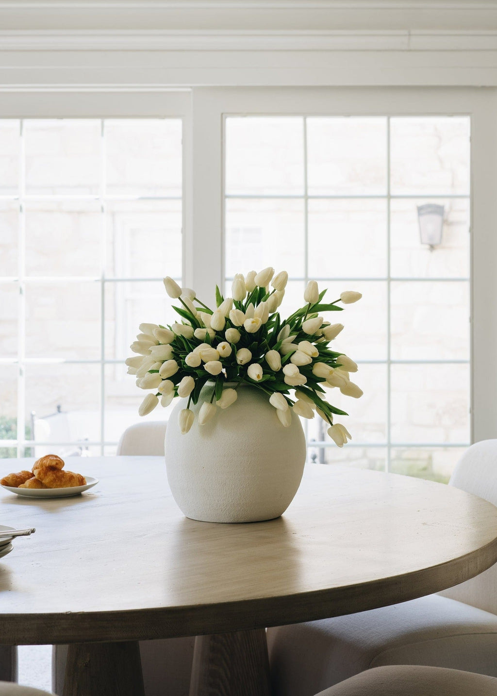 spring fake tulips in white konos vase