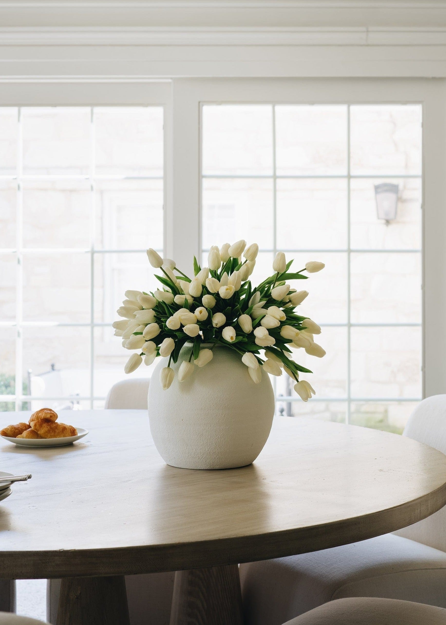 spring fake tulips in white konos vase