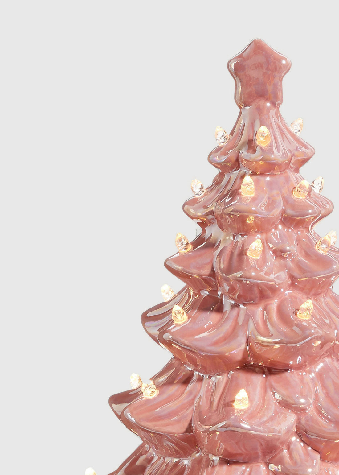 Close-up of pink ceramic vintage Christmas tree with lights