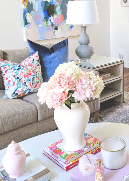 White ginger jar styled with faux flowers
