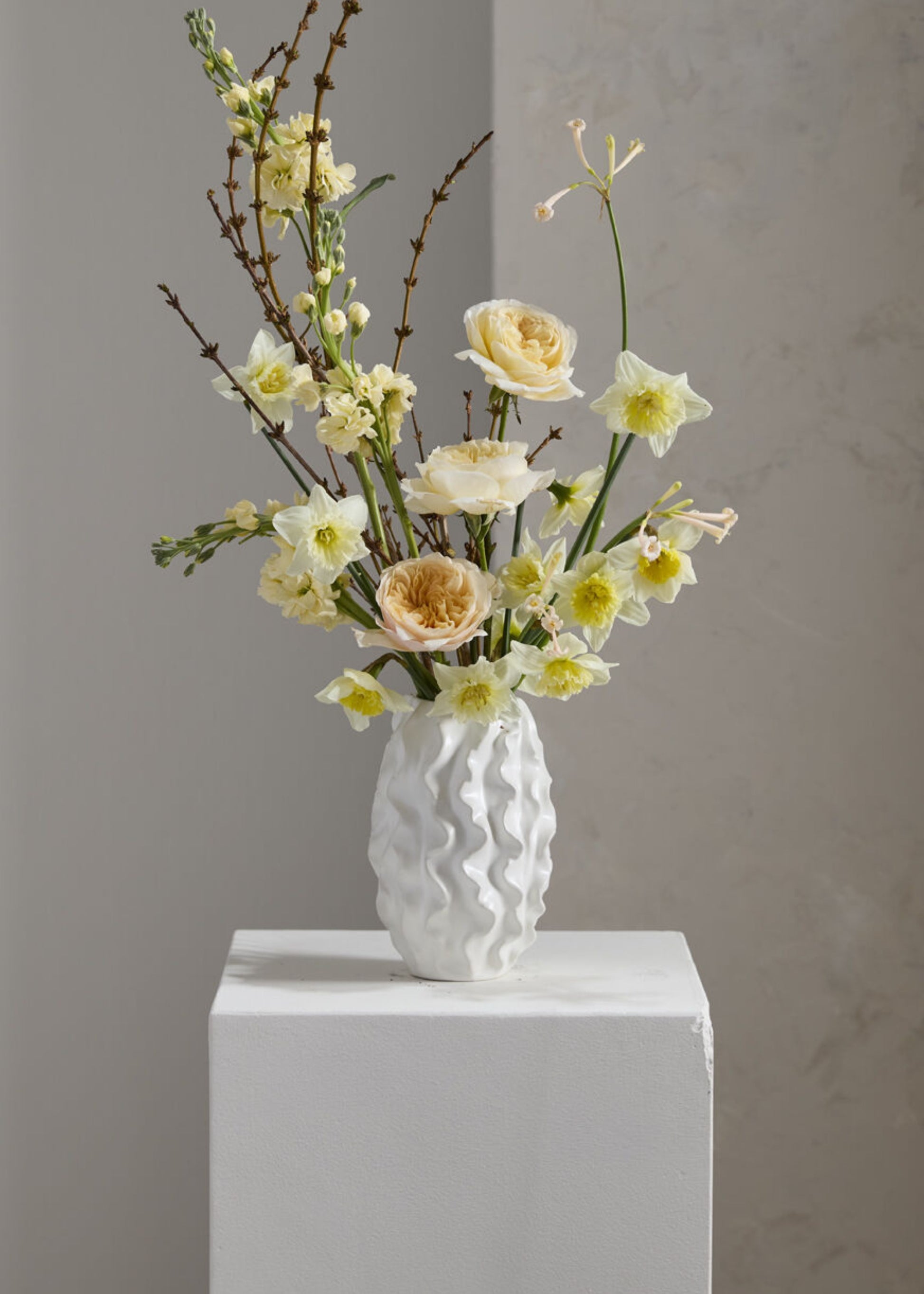 White textured vase with flowers 
