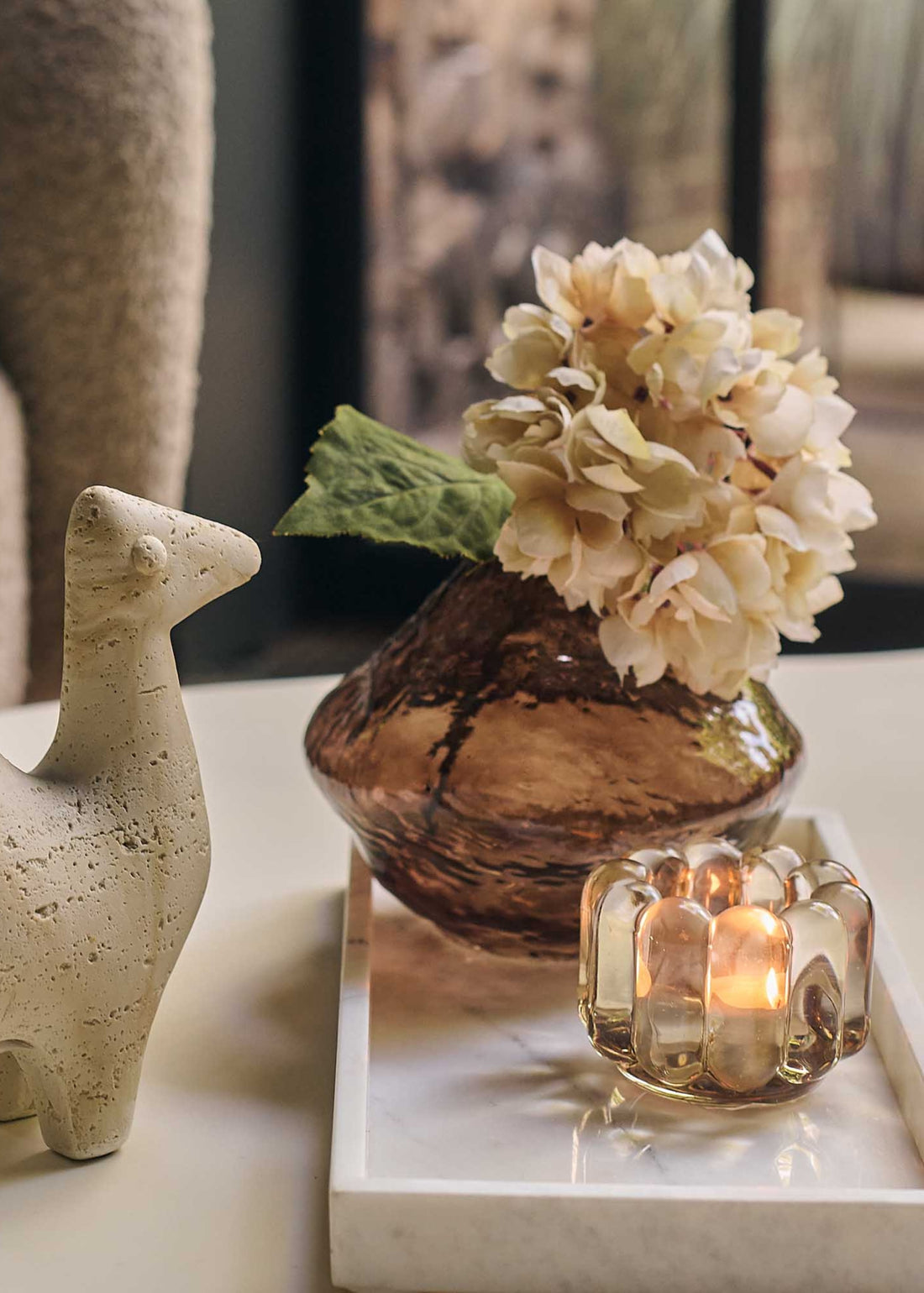 faux beige hydrangea stem in a bud vase