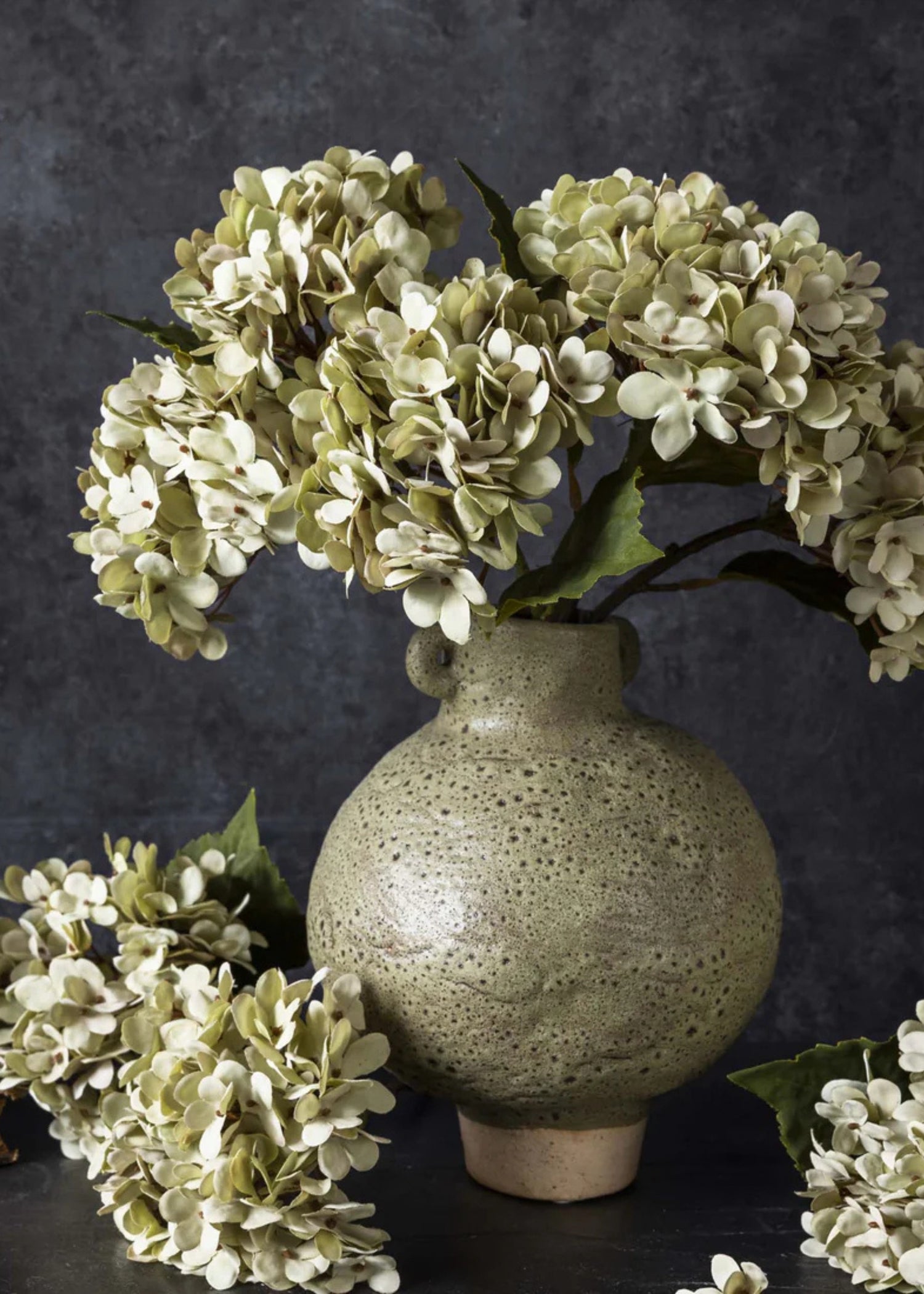 arrangement of fake hydrangeas in soft green