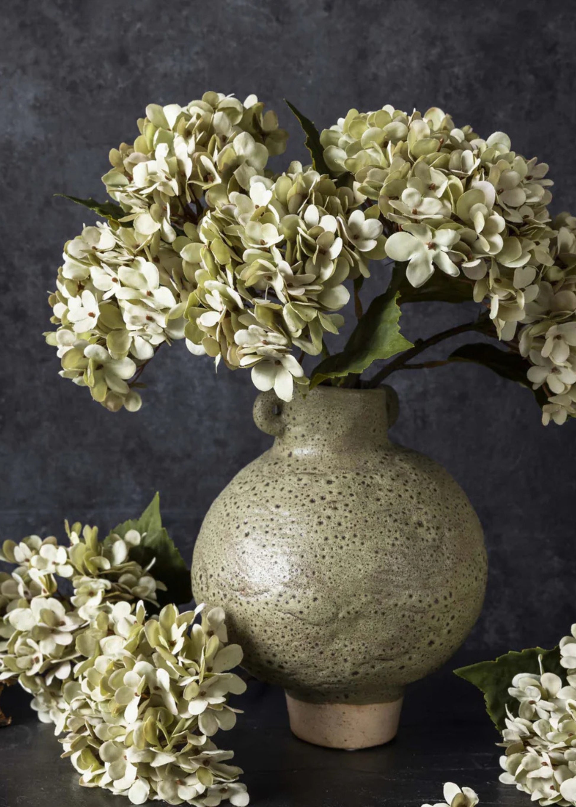 arrangement of fake hydrangeas in soft green