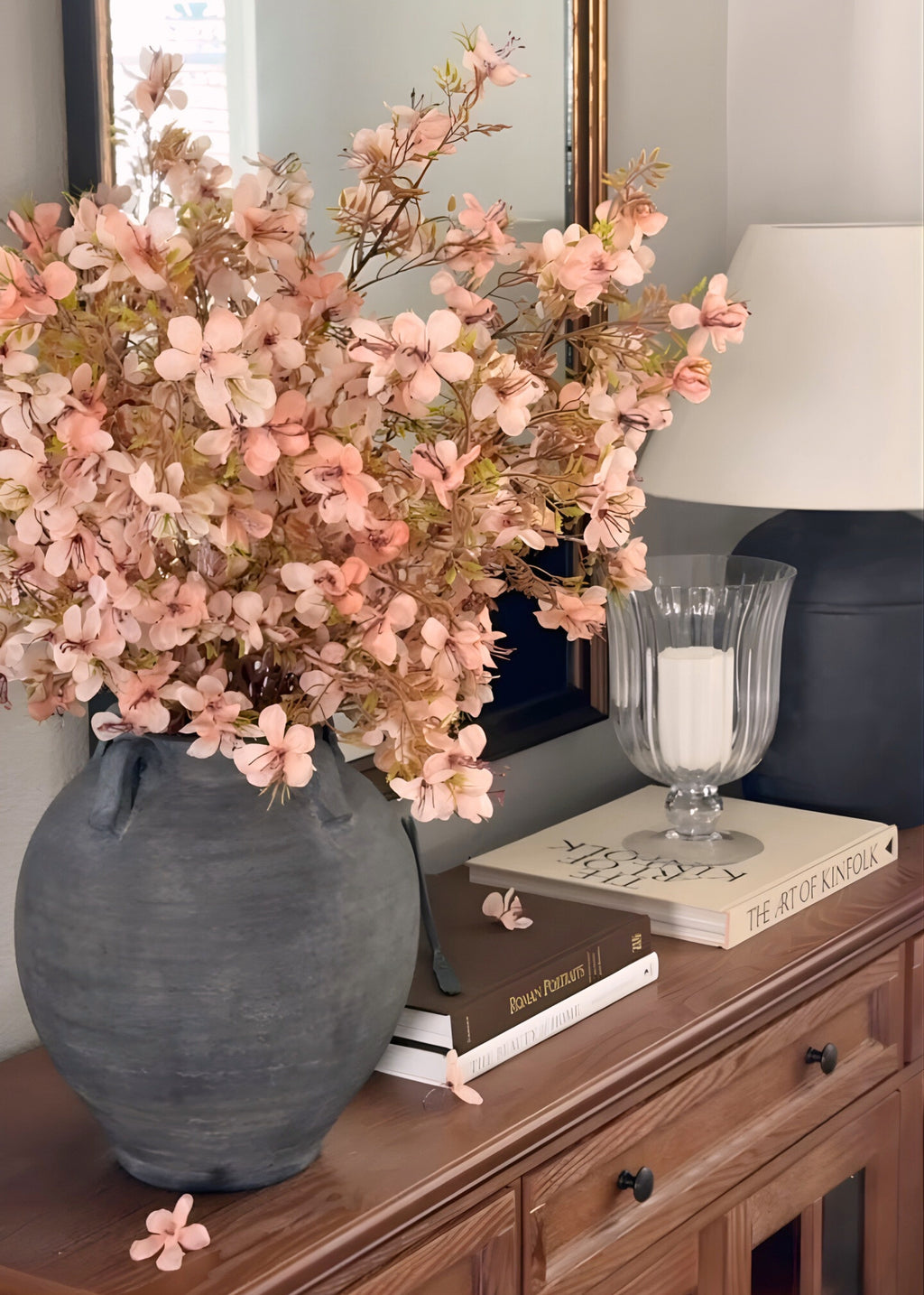 Decorative vase with pink prunus blossom flowers 