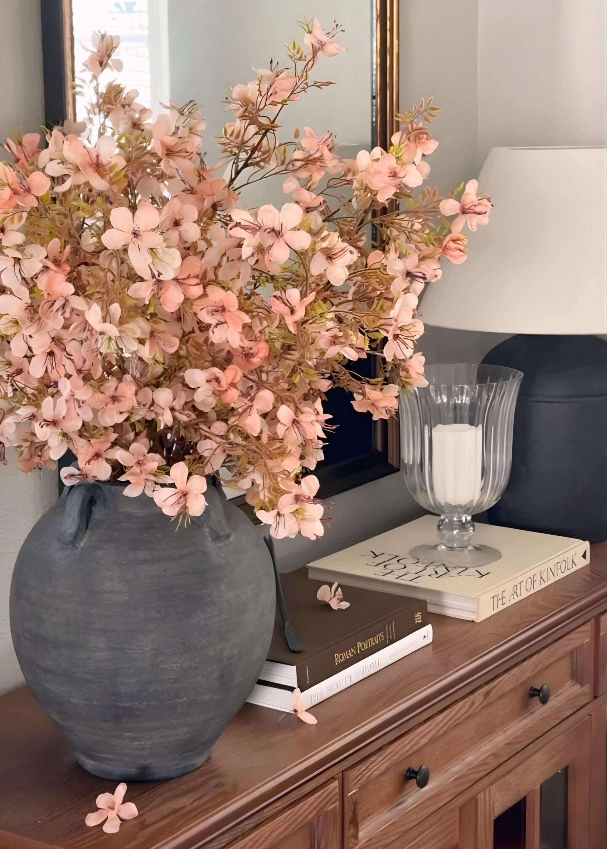 Decorative vase with pink prunus blossom flowers 