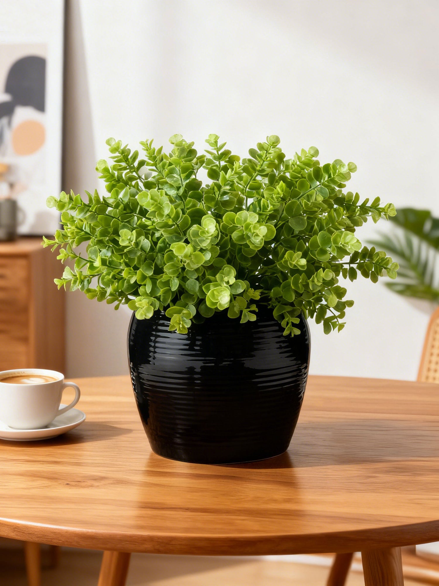 Artificial eucalyptus in the Afloral ribbed black vase on a dining table