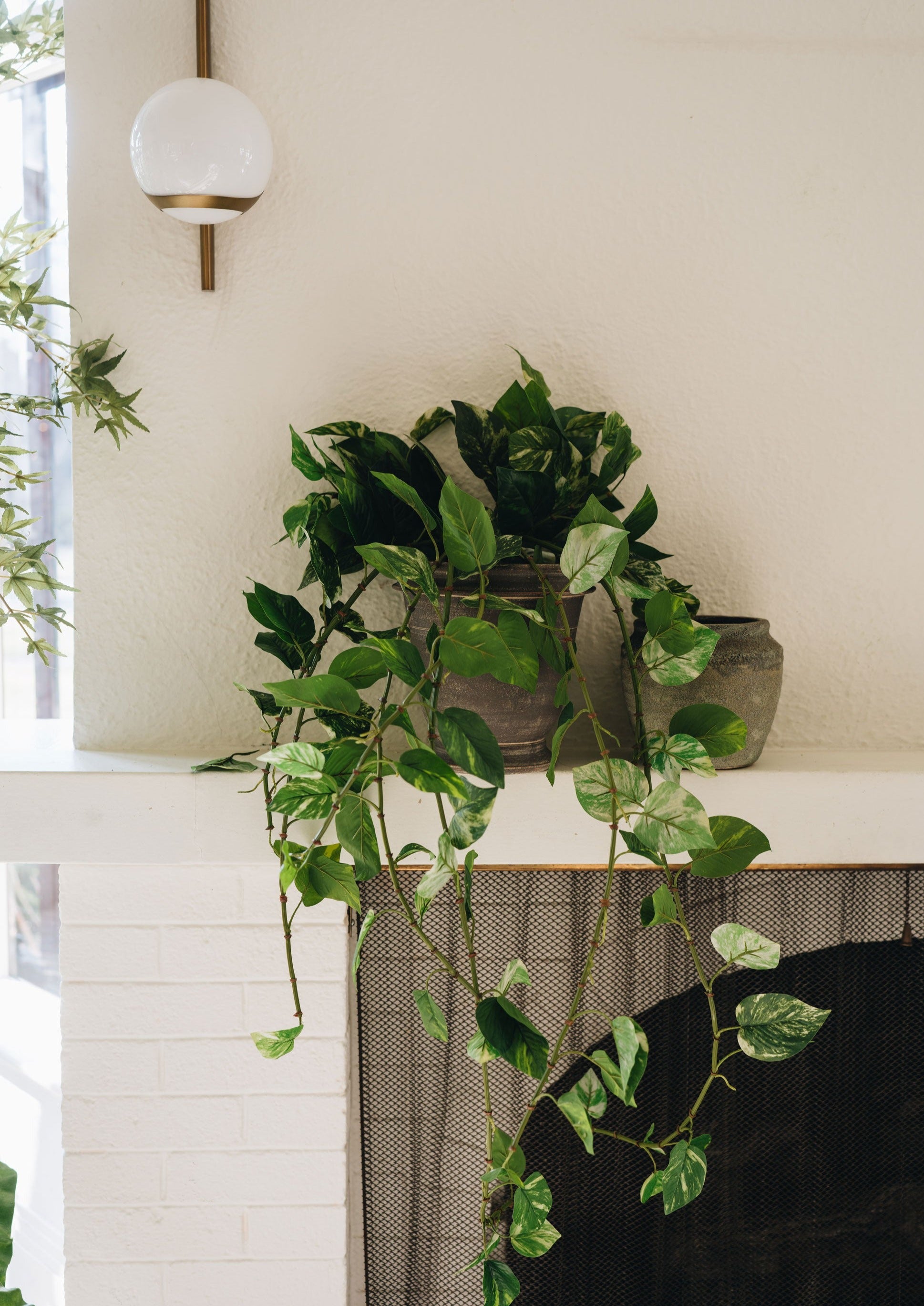 Earthy Pot on Mantel with Artificial Plants