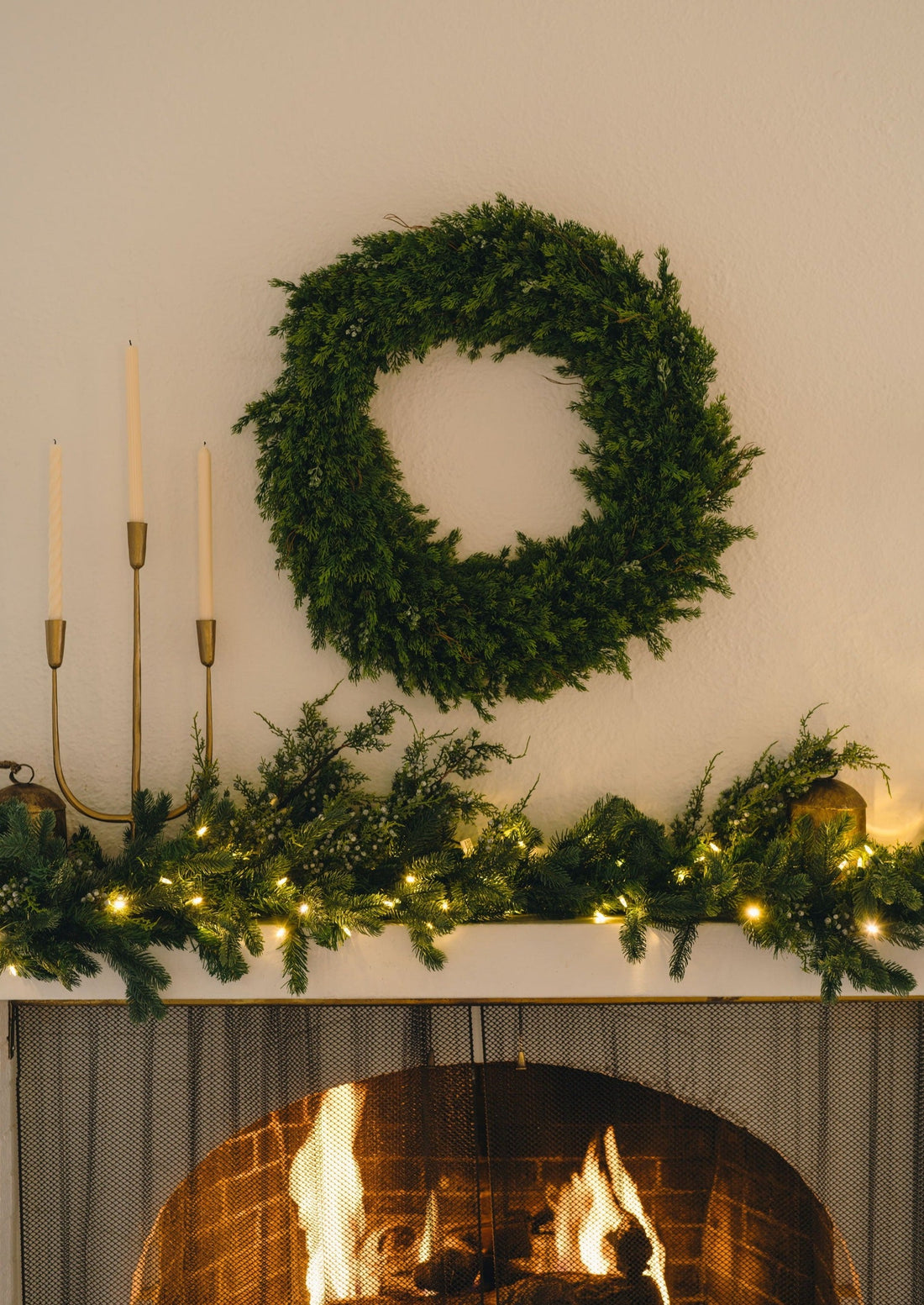 Cedar and Juniper Wreath Hanging over Decorated Mantel
