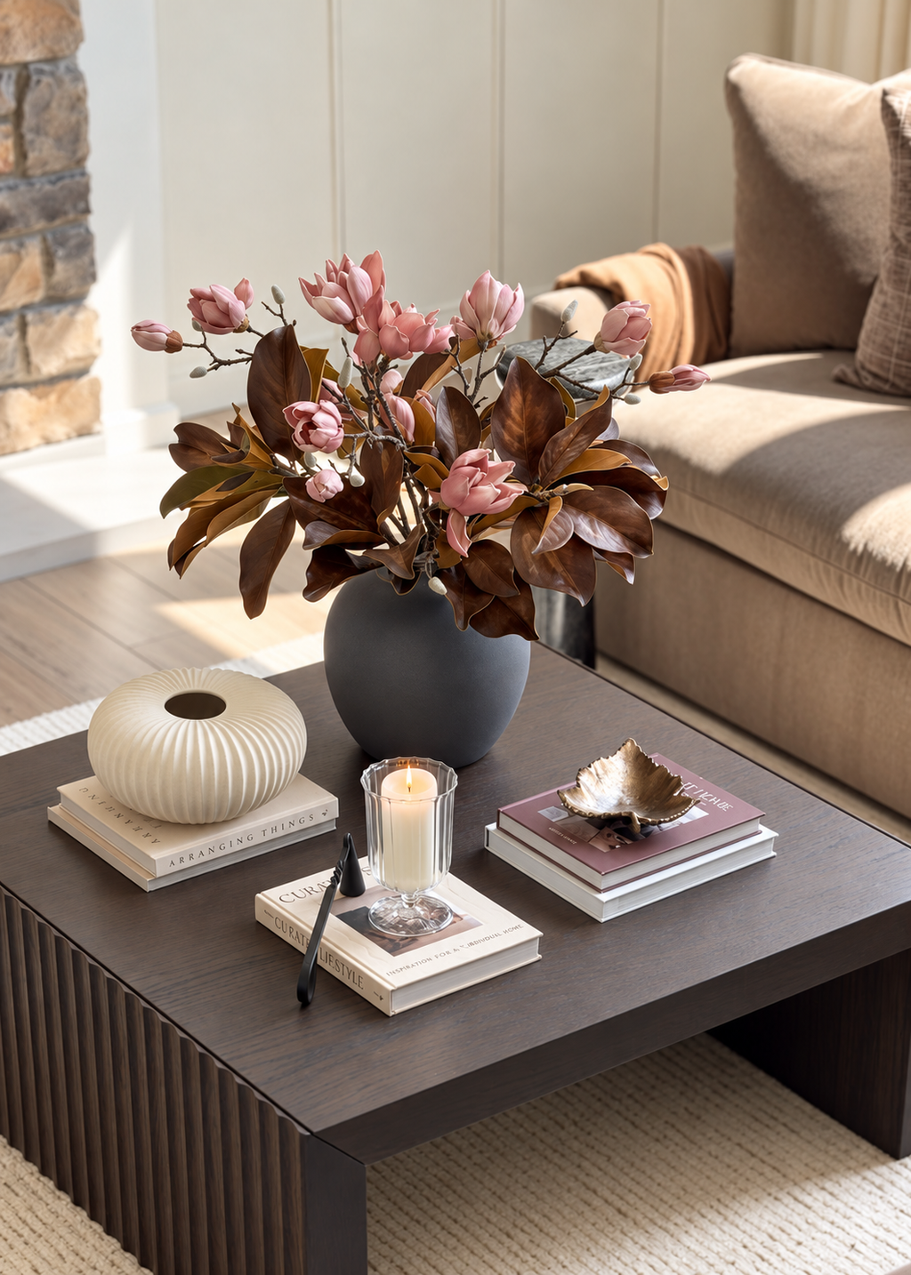 blush magnolia flowers styled with bronze magnolia leaves in a slate gray vase