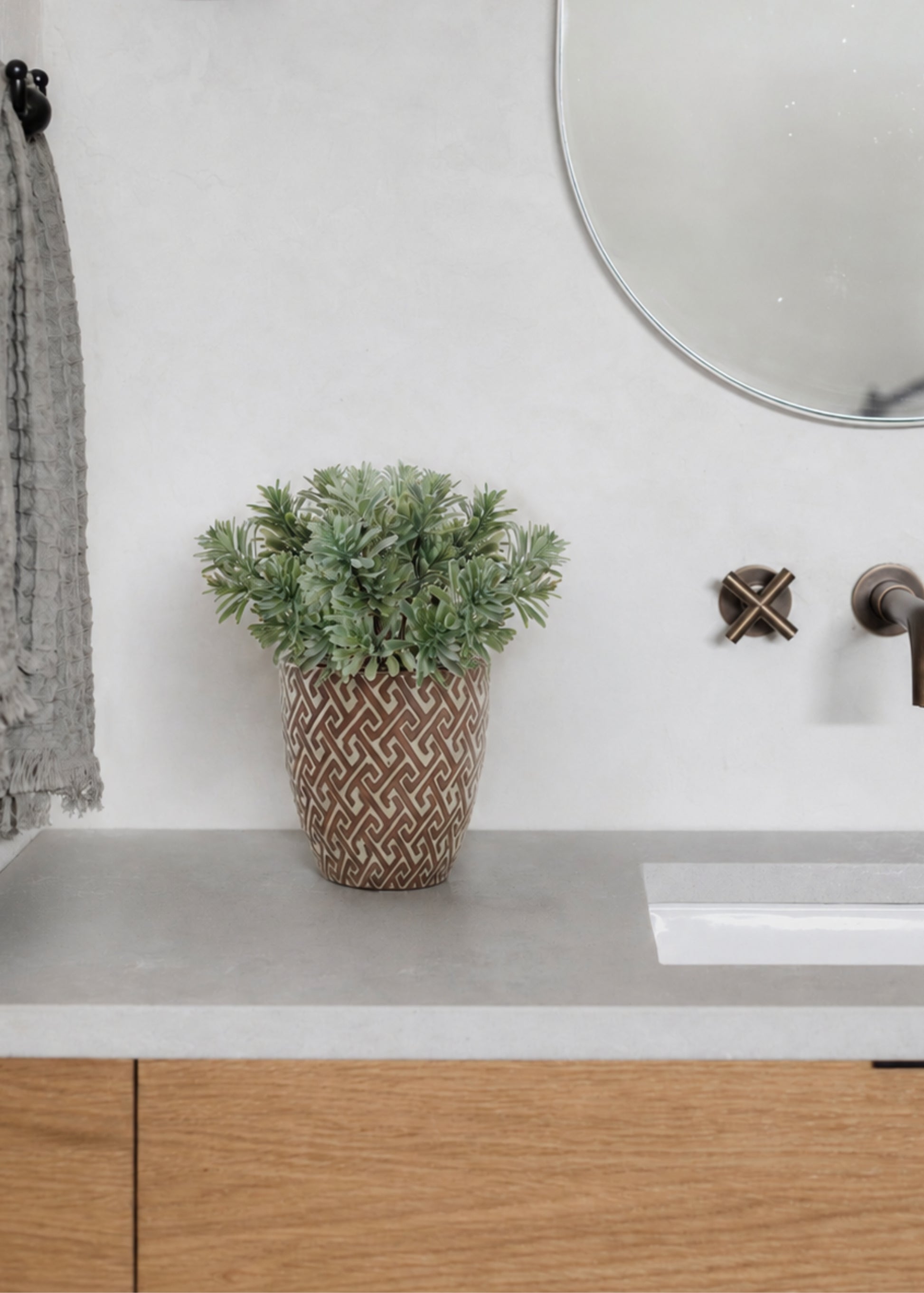 fake jade arranged in a pot in a bathroom