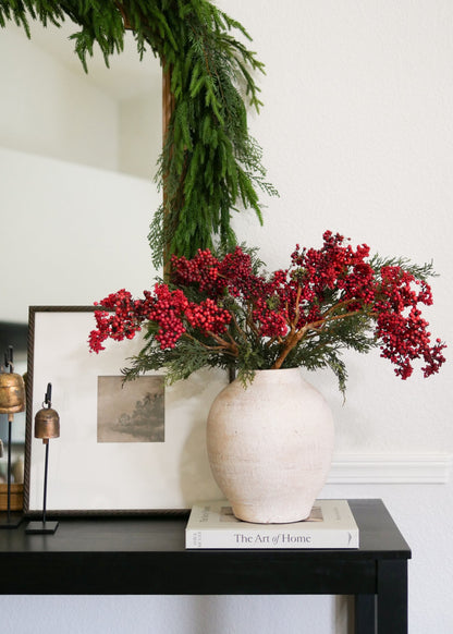Holiday arrangement with red berries and cedar