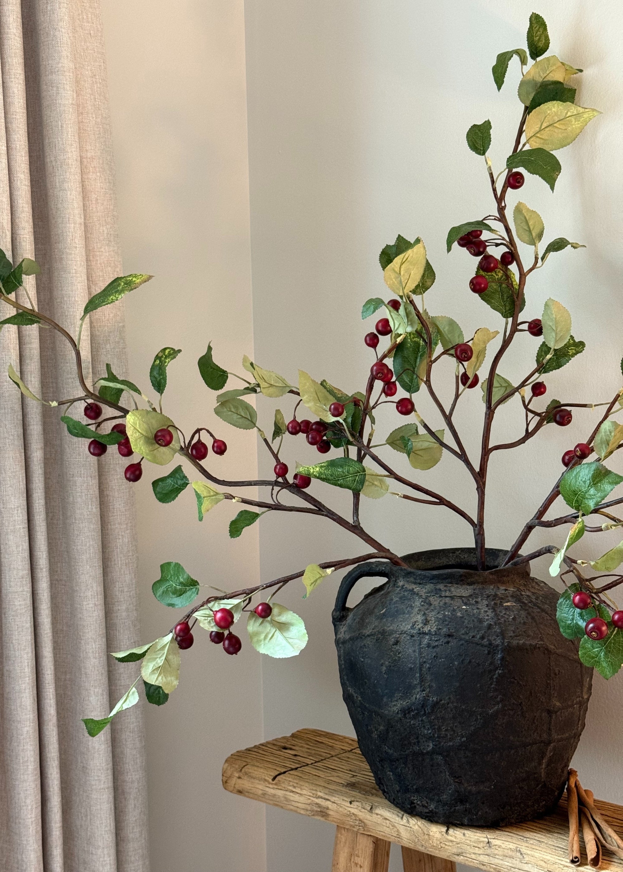 Red crabapples styled in a vase