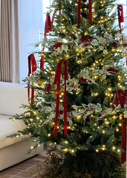 frosted holly garland decorating a christmas tree