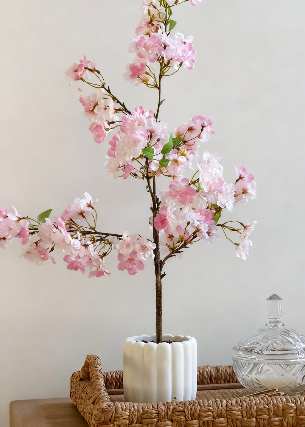 Artificial cherry blossom tree in a white vase 