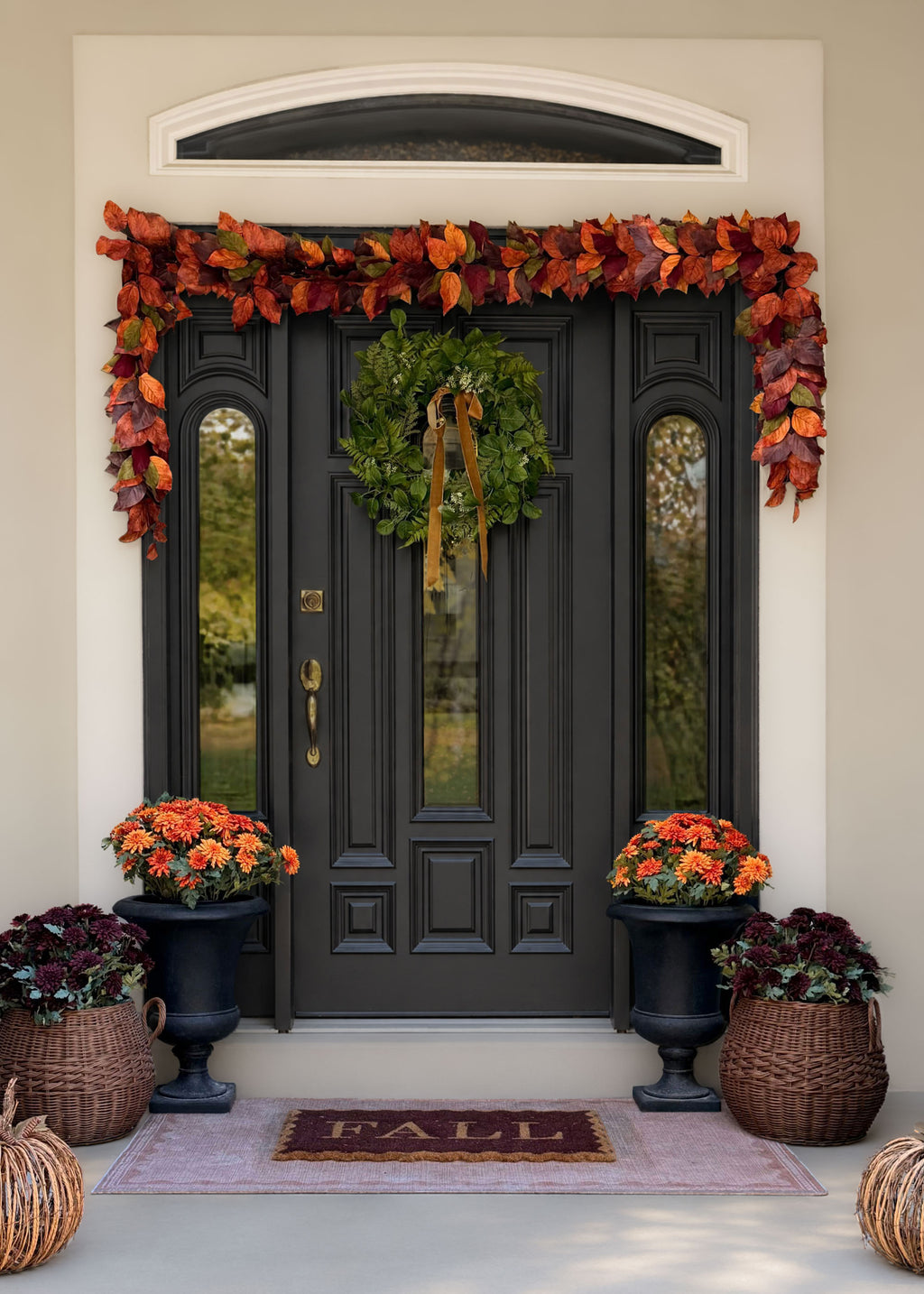 fall porch with a salal garland and wreath and decorative faux mums
