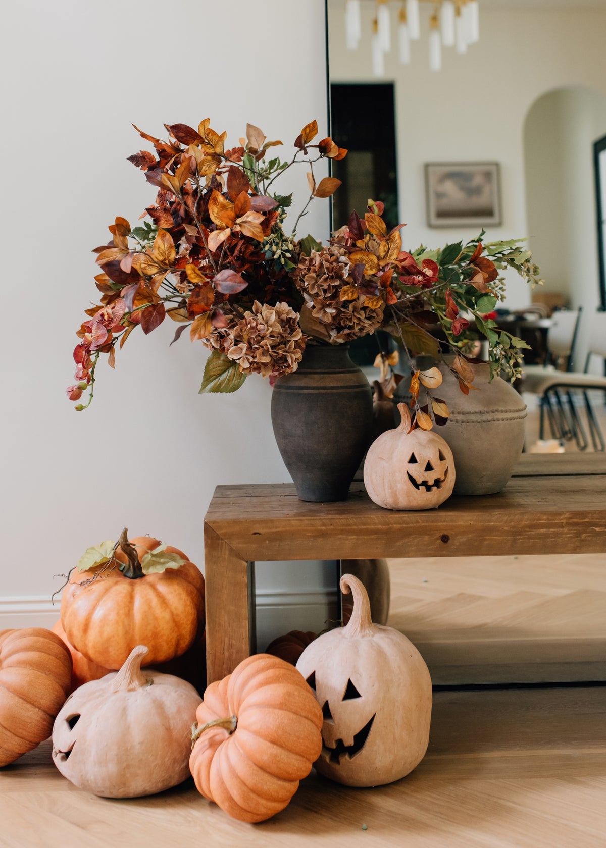 fall leaves and flowers arranged with pumpkins